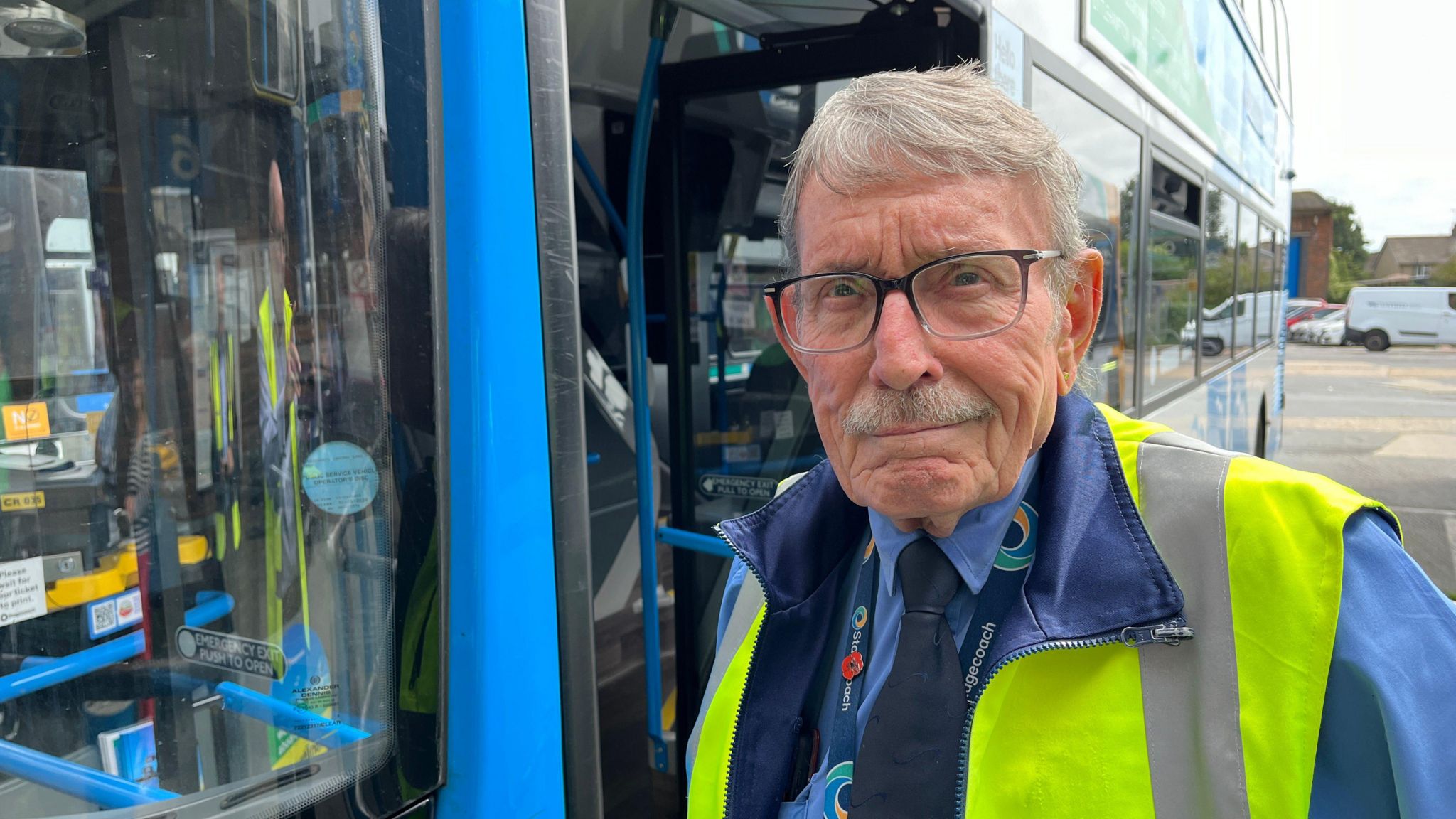 Royston Shaw stood outside a bus