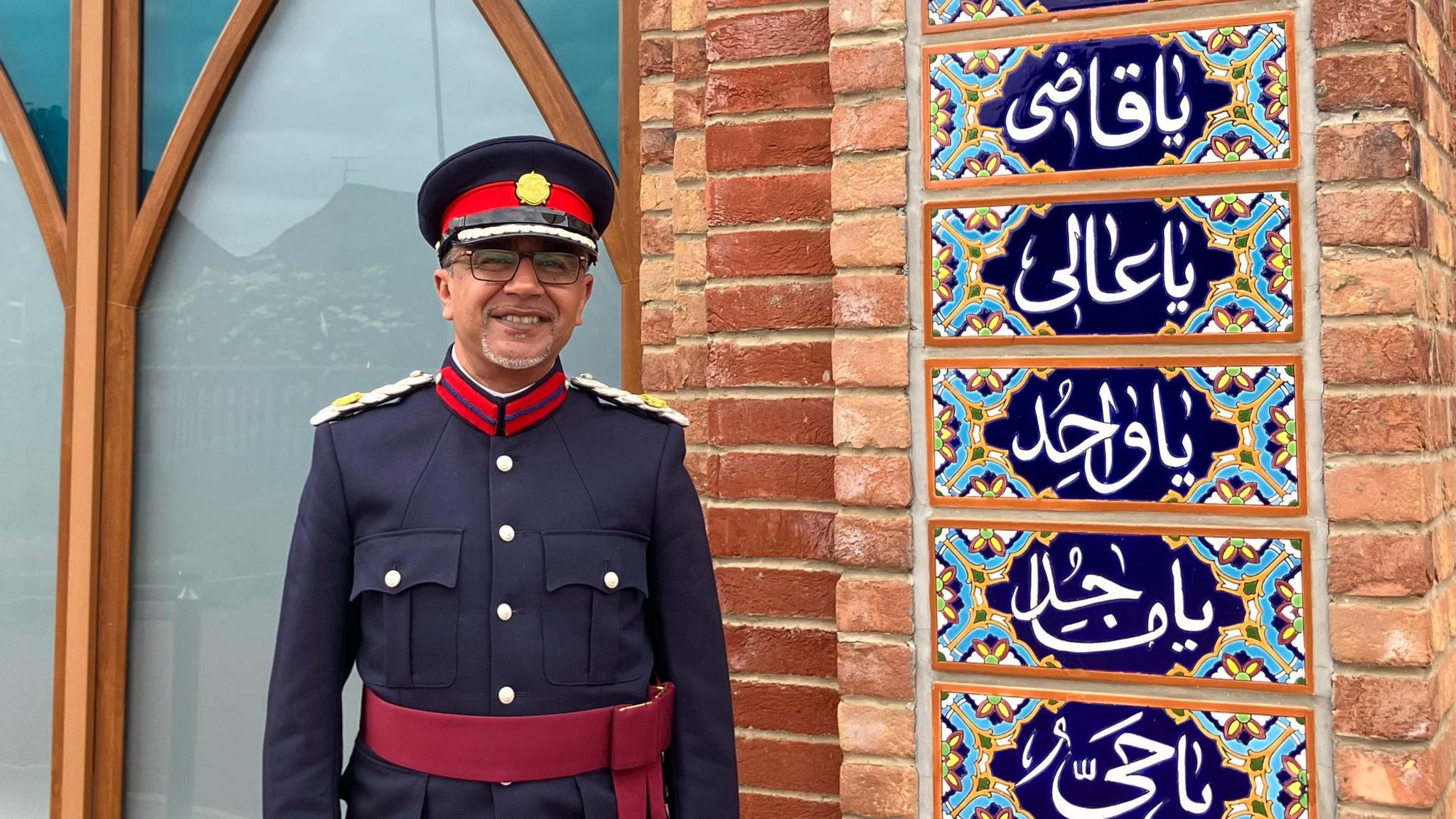 Rizwan Rahemtulla  wearing a blue and red Deputy Lord Lieutenant's uniform