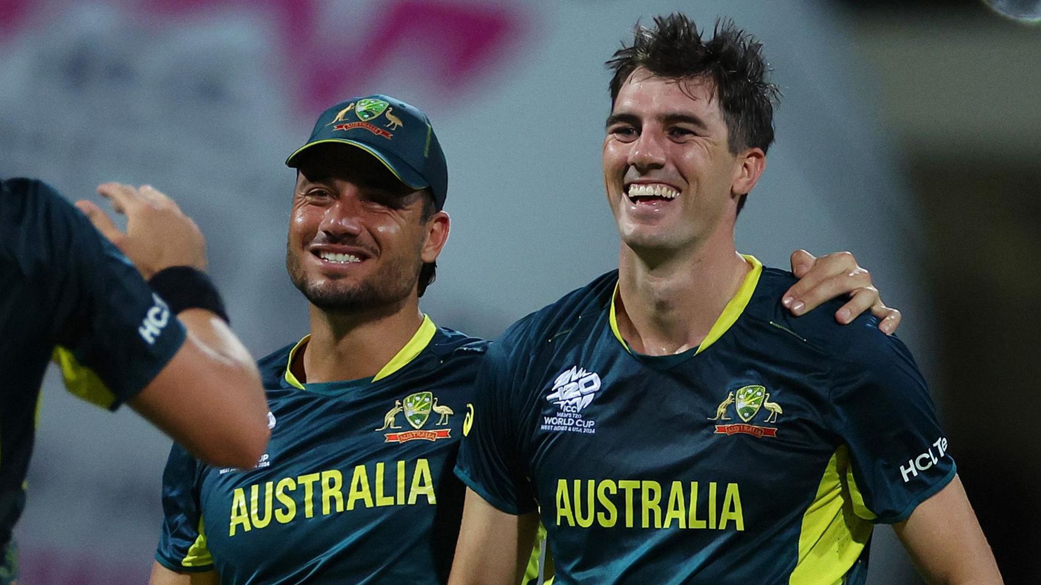 Australia's Pat Cummins and Marcus Stoinis celebrate a wicket against Bangladesh at 2024 T20 World Cup