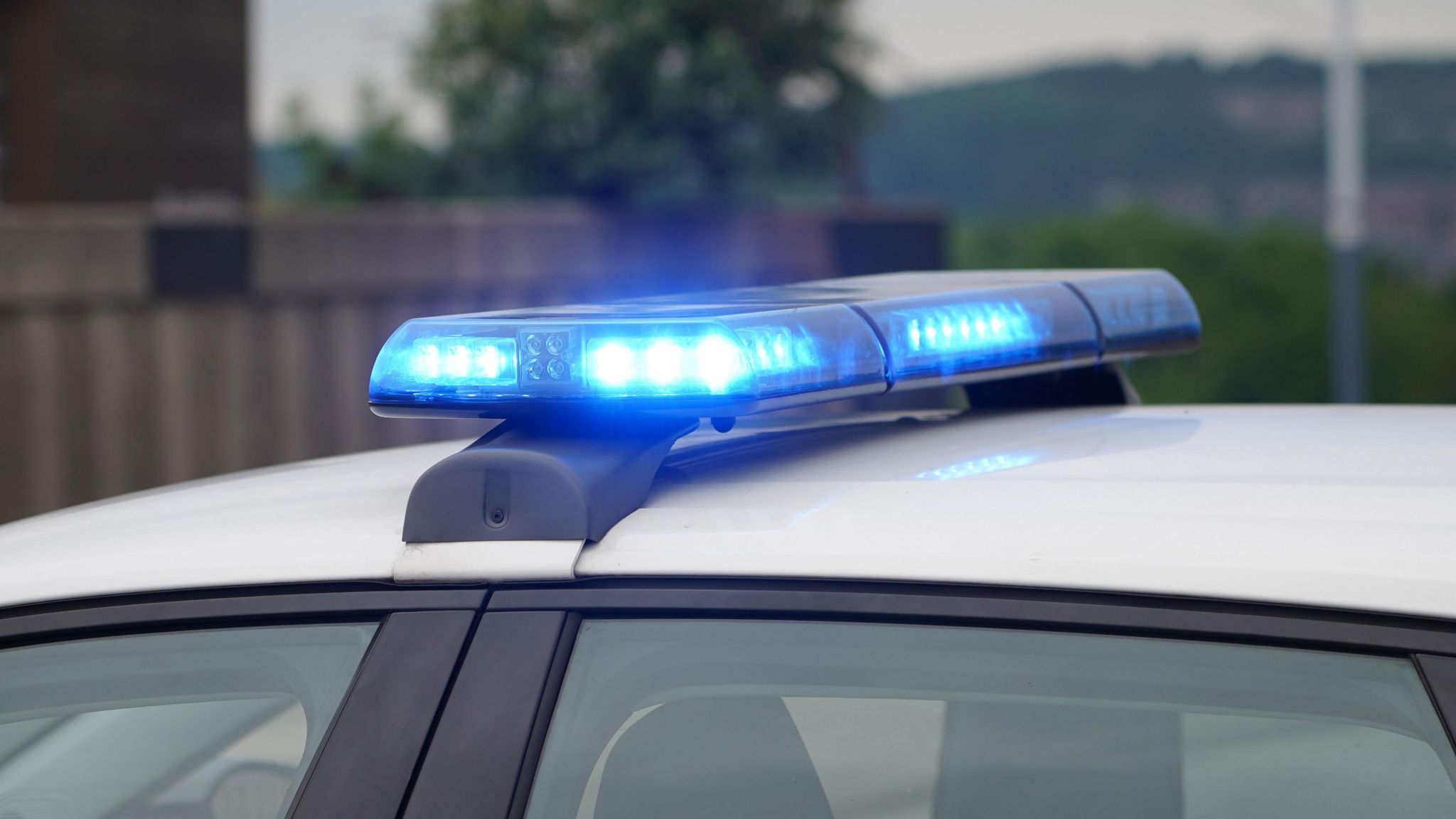 A file image of blue lights flashing on a police car.