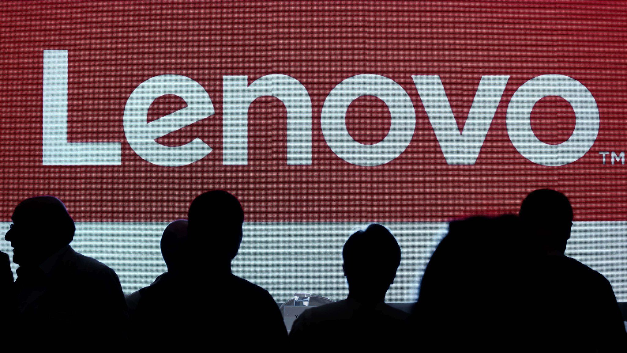 Lenovo's brand logo is displayed on a screen before a press conference in Hong Kong