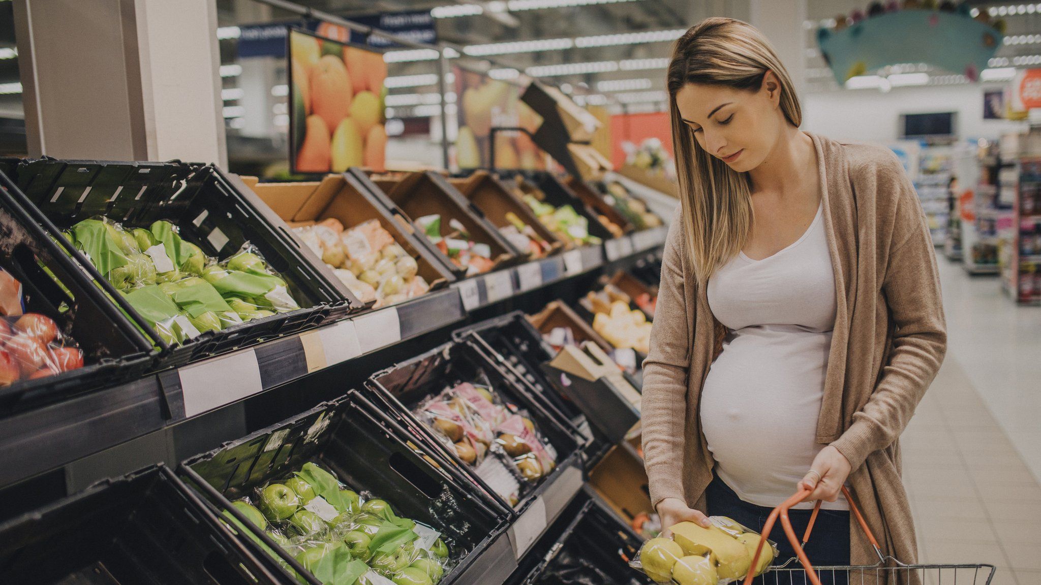pregnant woman shopping for food