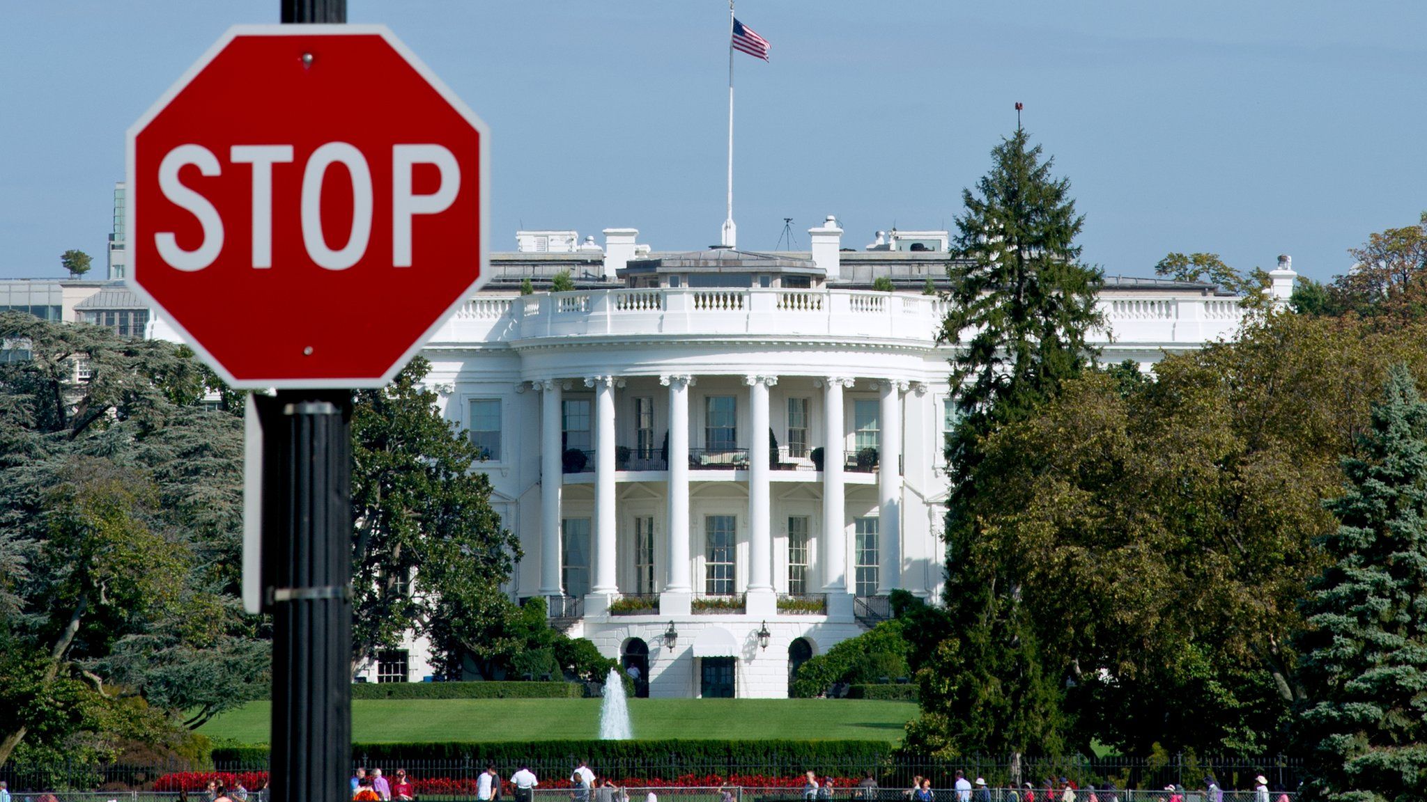 The White House is seen behind a stop sign in Washington, DC, on October 1, 2013.