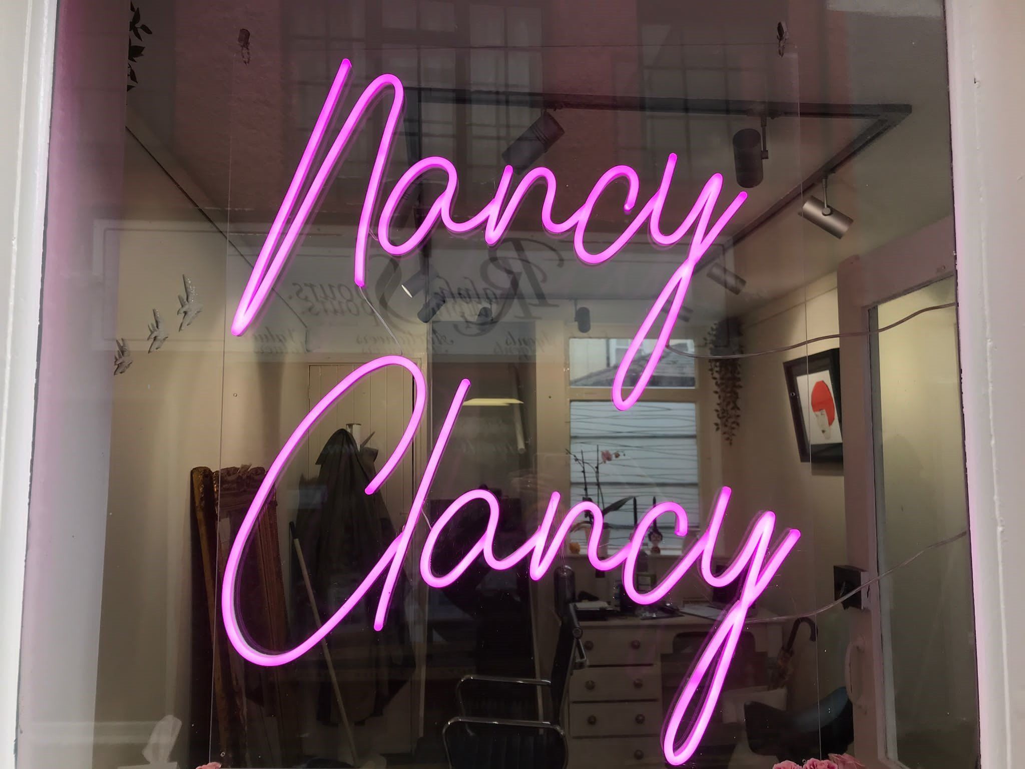 Pink neon Nancy Clancy sign
