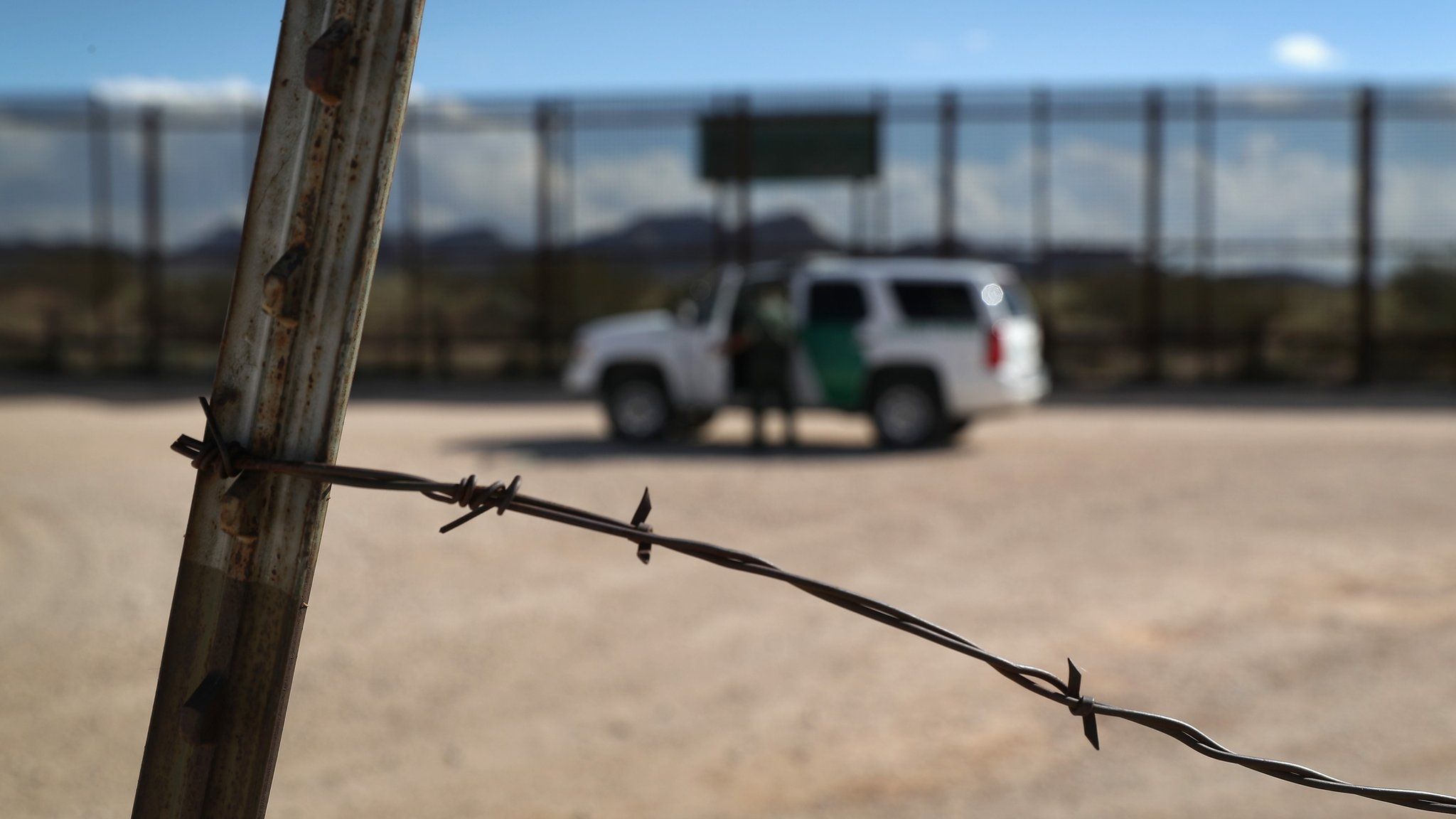 A barbed-wire border fence stands in front of the newer U.S.-Mexico border fence on October 4, 2016 in Sunland Park, New Mexico