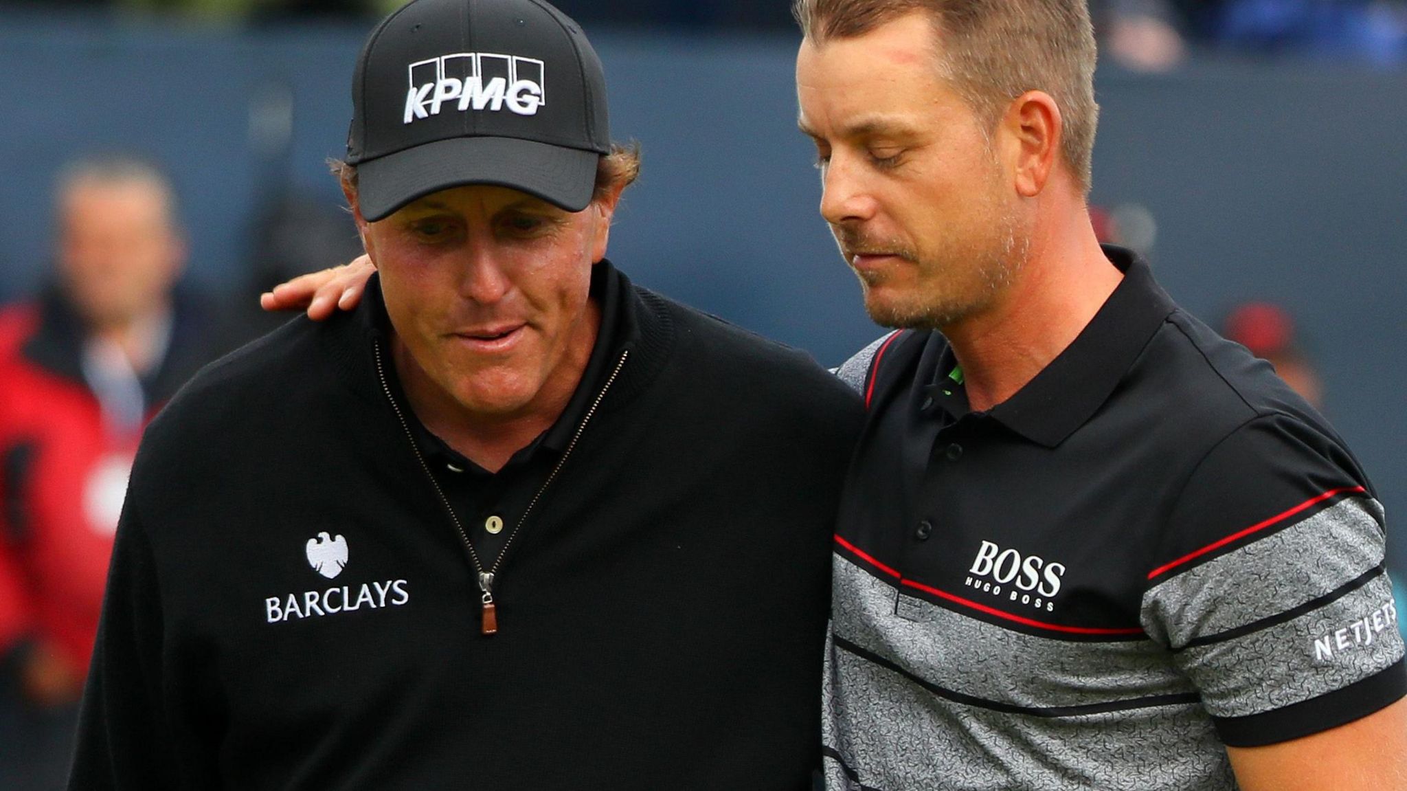 Phil Mickelson and Henrik Stenson leave the 18th green at Royal Troon arm-in-arm at the conclusion of the 2016 Open