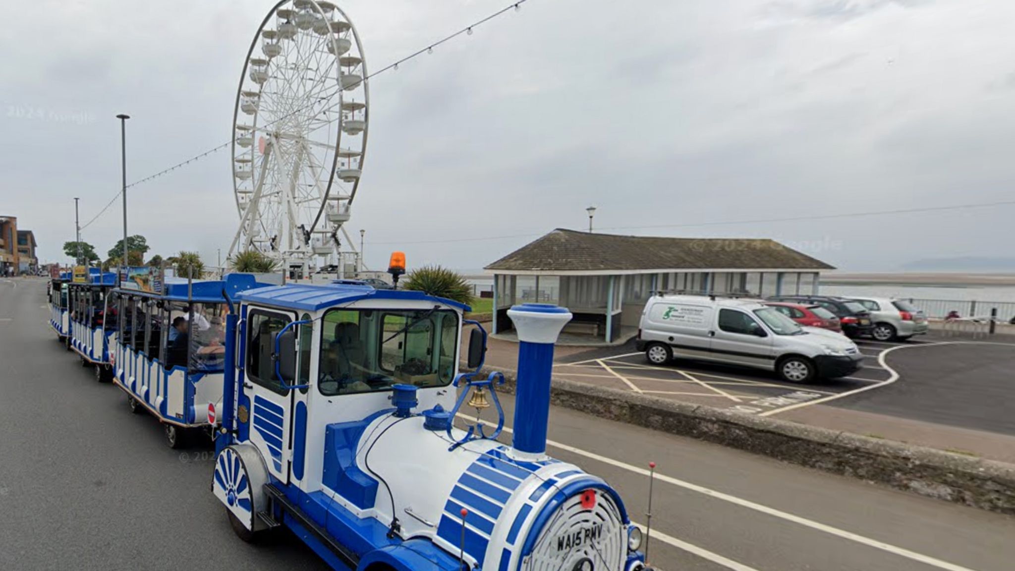 Exmouth's seafront, with a road train  and ferris wheel