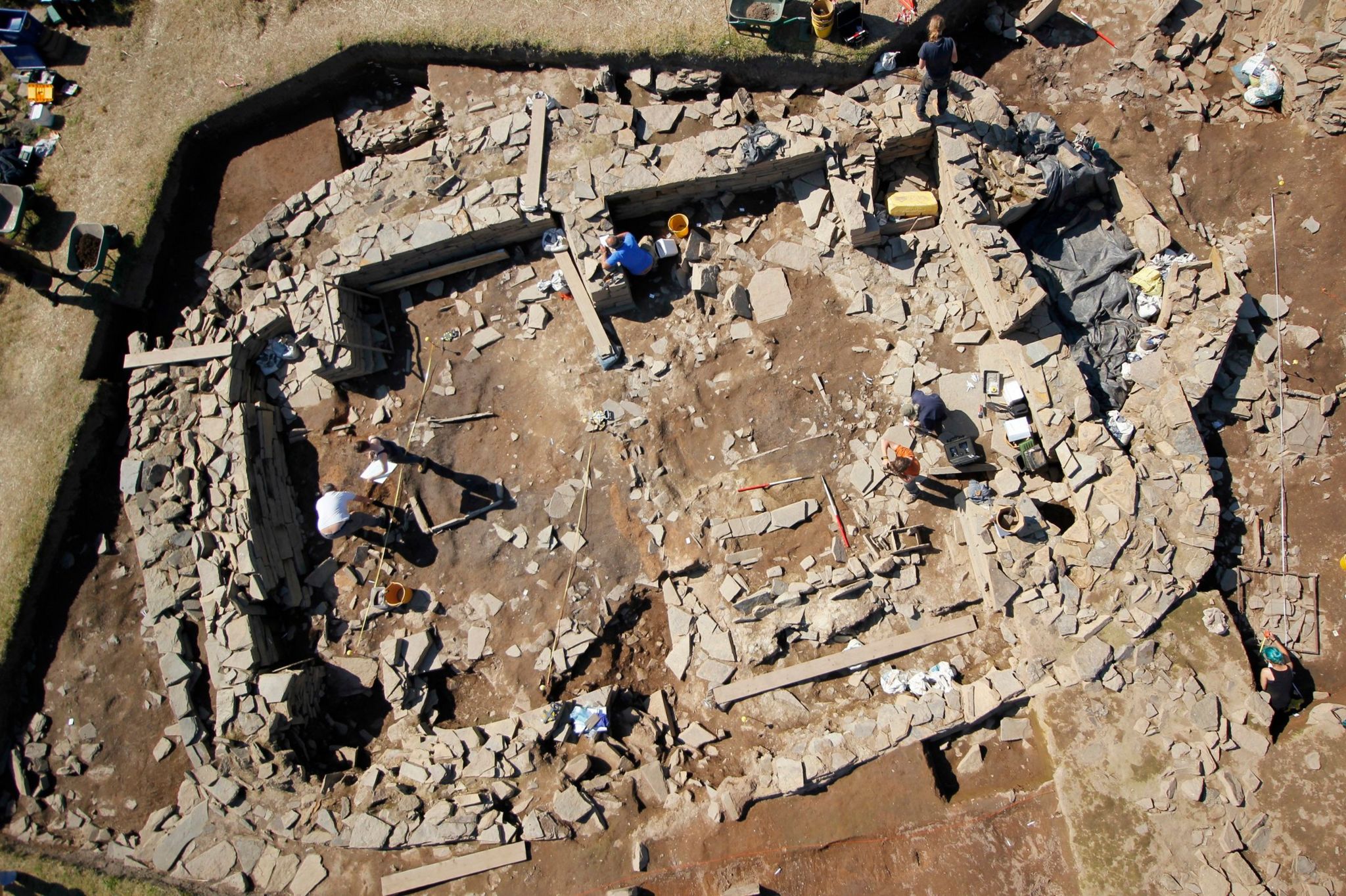 An aerial view of a large sub-rectangular building, approximately 17 metres long, with 1.6-metre-thick walls standing to at least 1.5 metres high.