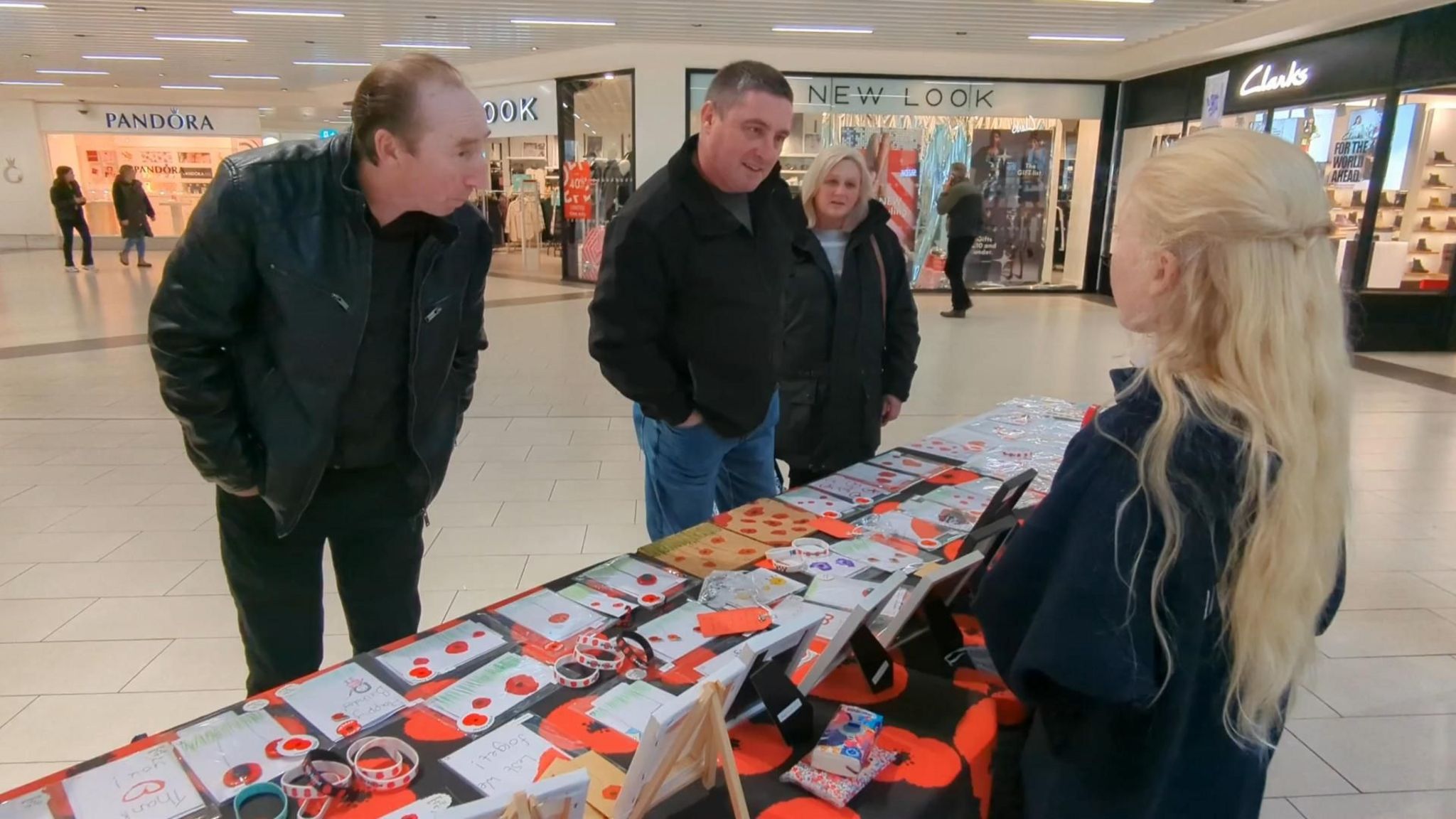 Ruby selling her products to customers in a shopping centre