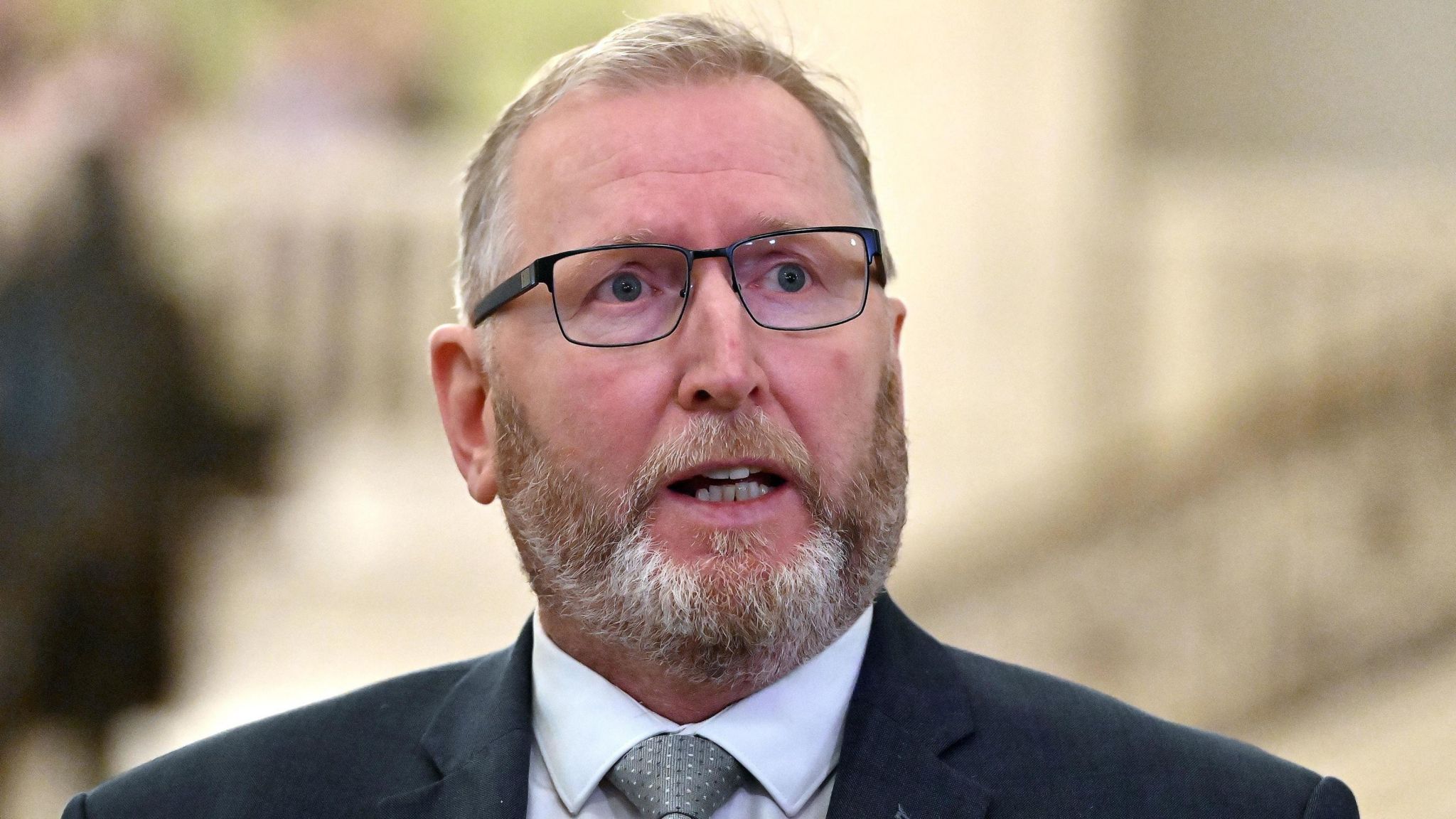 Doug Beattie wearing glasses, a grey suit and light grey tie with white shirt