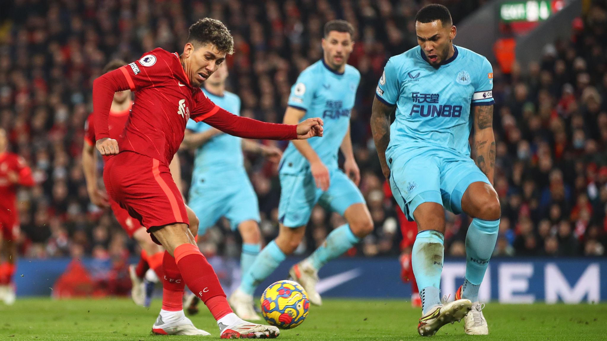 Roberto Firmino and Jamal Lascelles in action