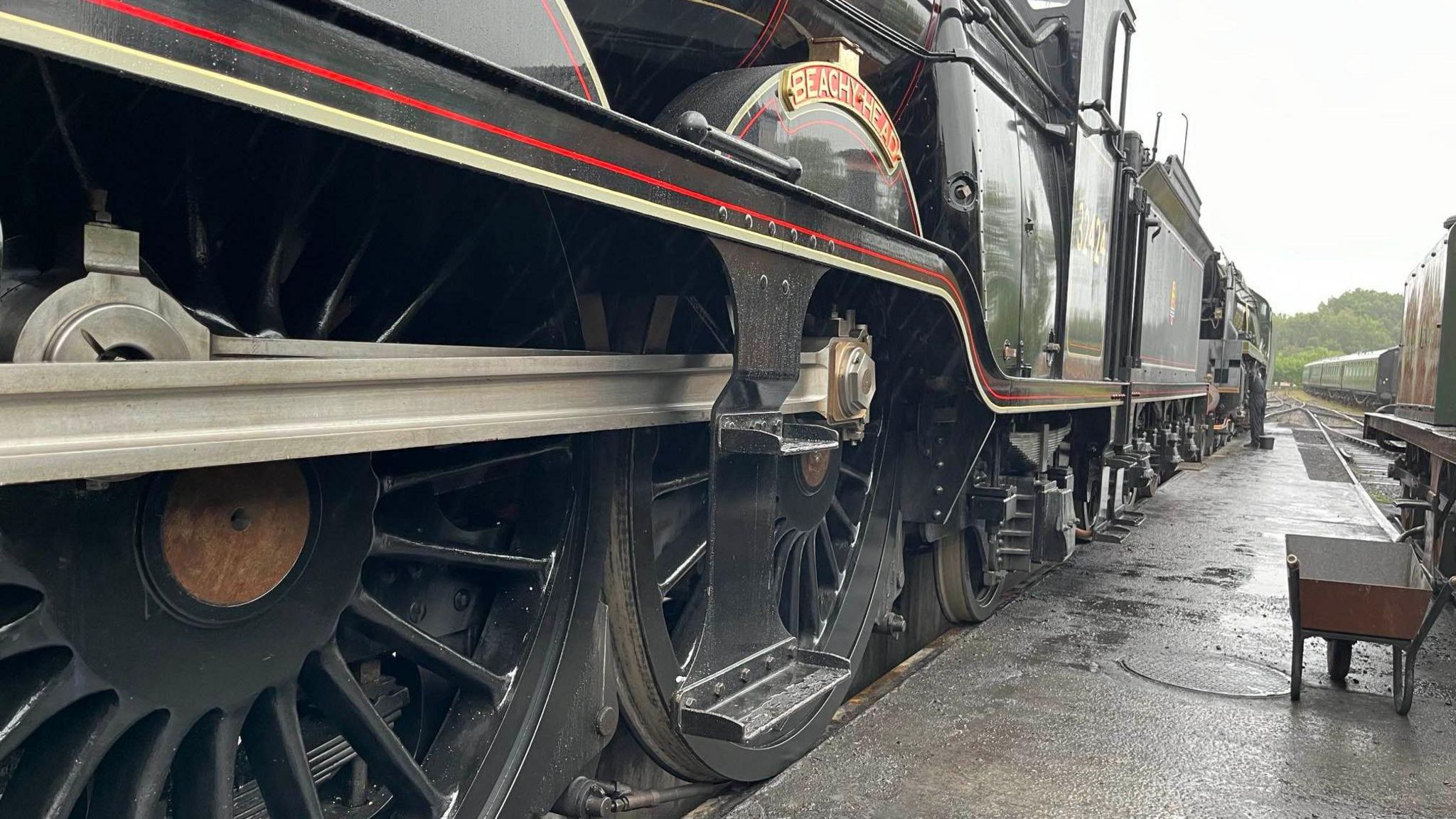 The side profile of a black locomotive. 