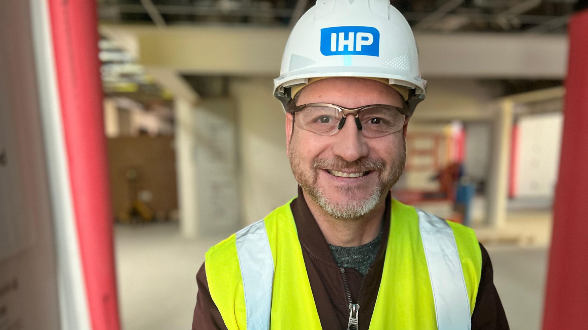 Image of Kevin Clark. He is pictured inside the hospital, wearing a hi-vis vest and hard hat.