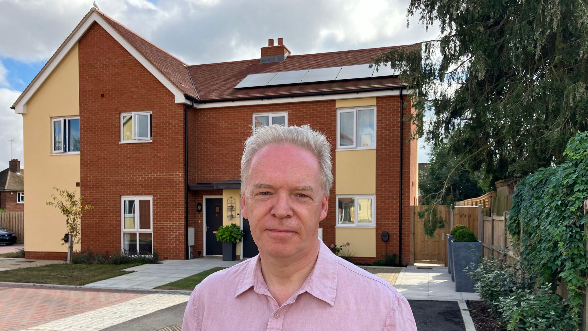 Councillor Stephen Robinson standing in front of new houses in Chelmsford