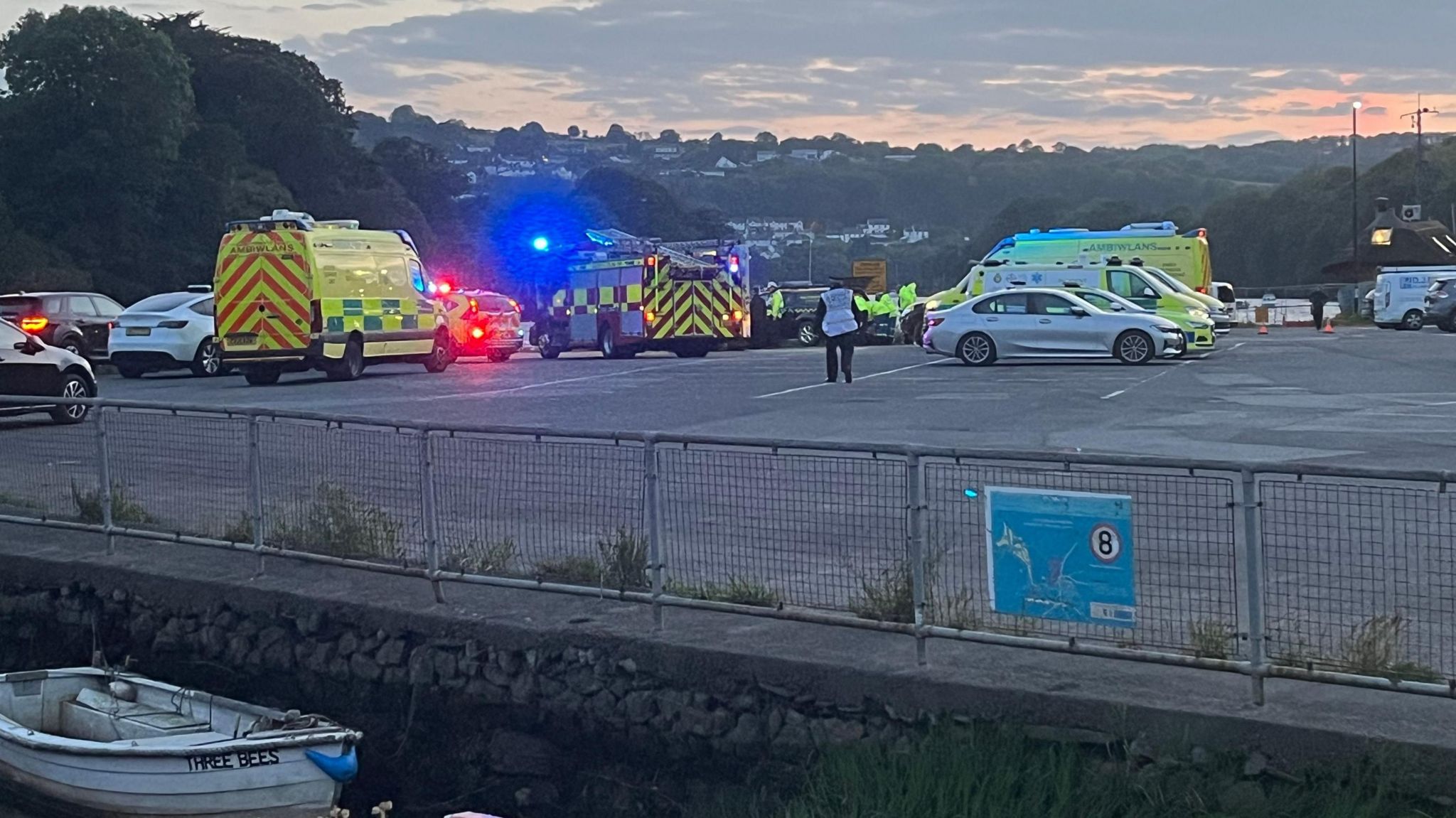 Ambulances and police cars parked in a car park by the river last night