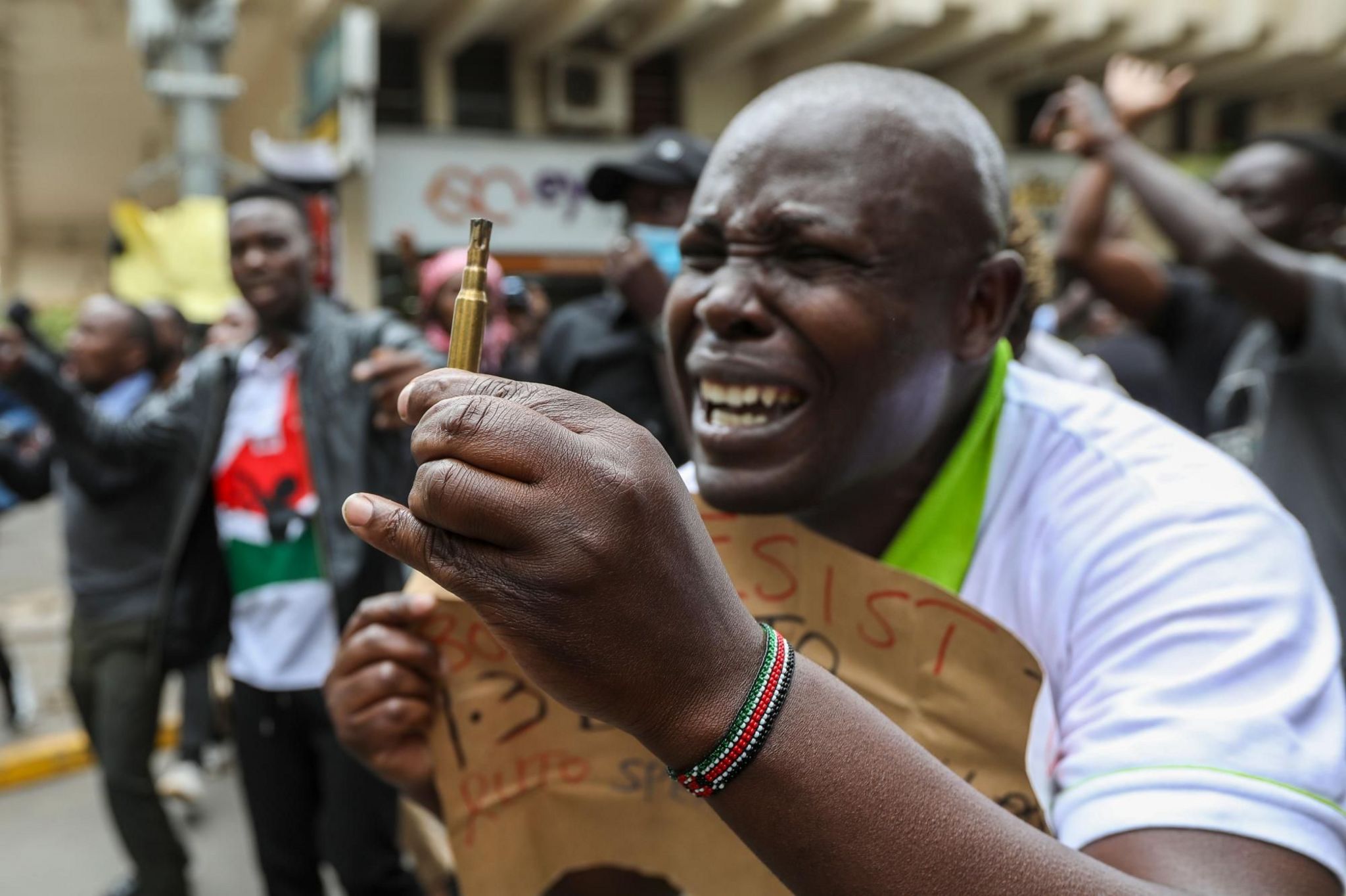 A Kenyan protester holds a spent bullet
