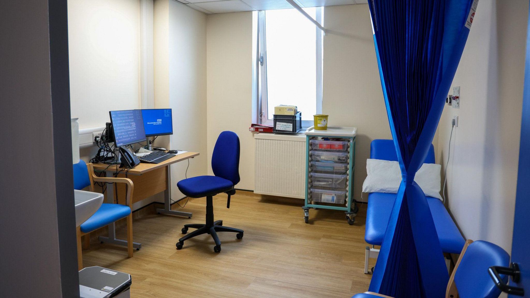 A room in a clinic in a hospital with curtains around a bed