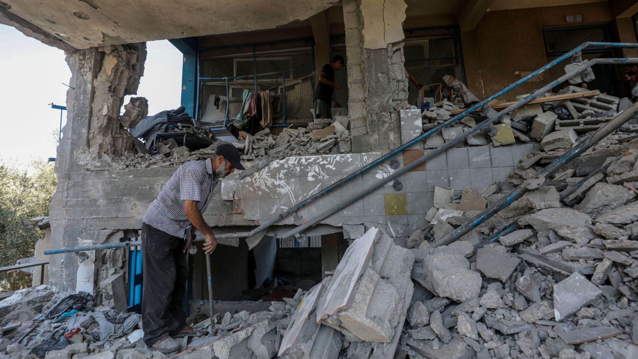 A man surveys the damage at the Abu Oraiban School