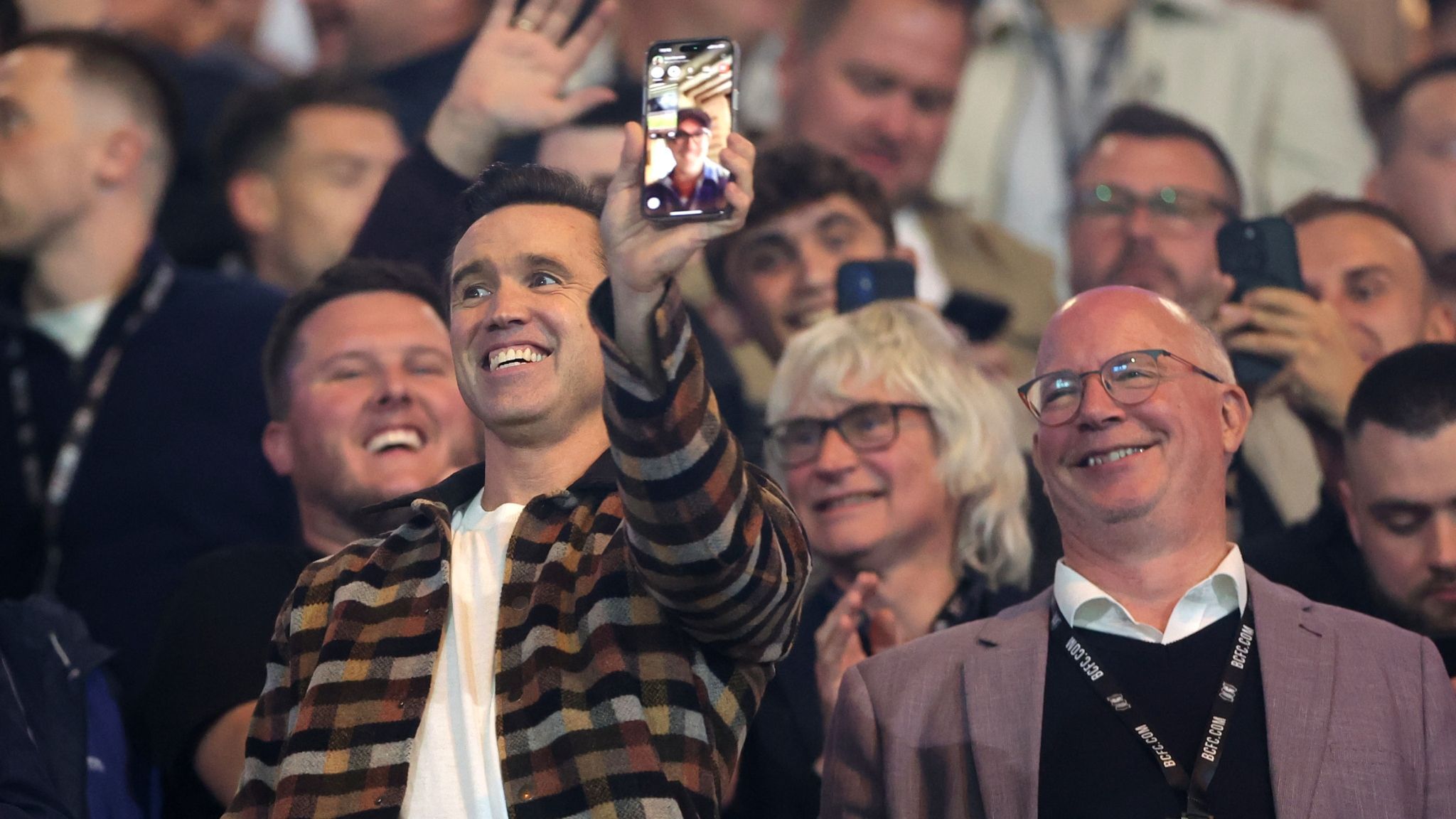 Rob McElhenney, co-owner of Wrexham video calls co-owner, Ryan Reynolds prior to the League One match between Birmingham City and Wrexham at St Andrew’s at Knighthead Park.