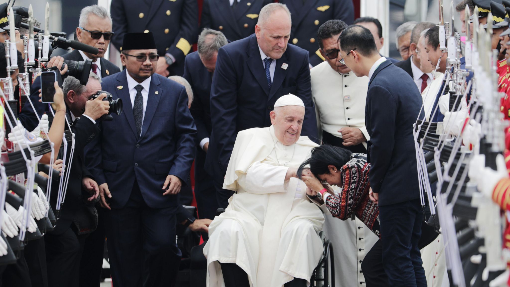 Pope Francis is welcomed during his arrival at Soekarno-Hatta International Airport in Jakarta