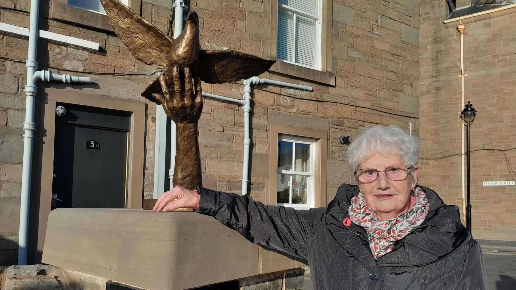 Norma Nicolson next to the statue
