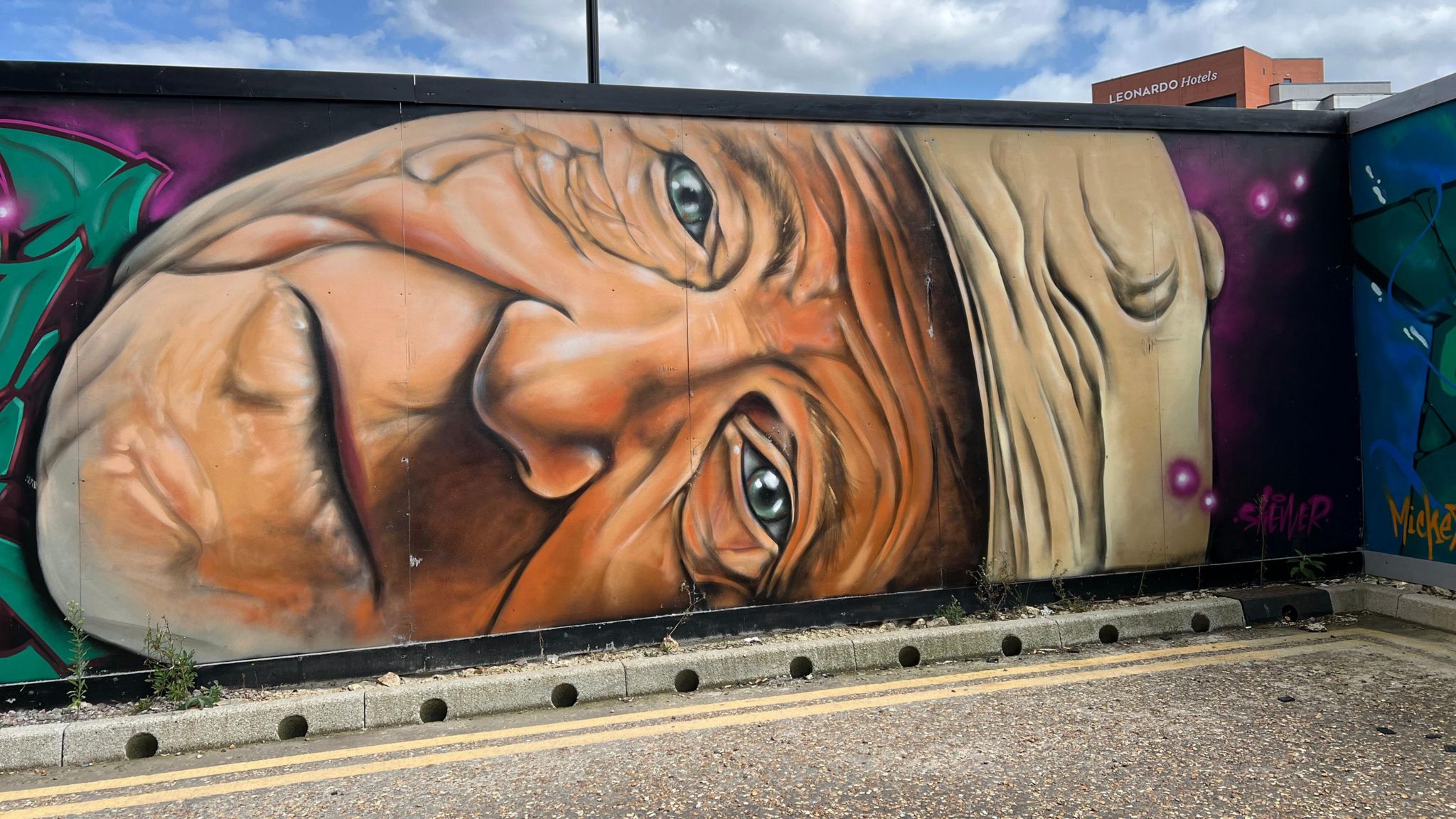 Mural of a male face on its side.