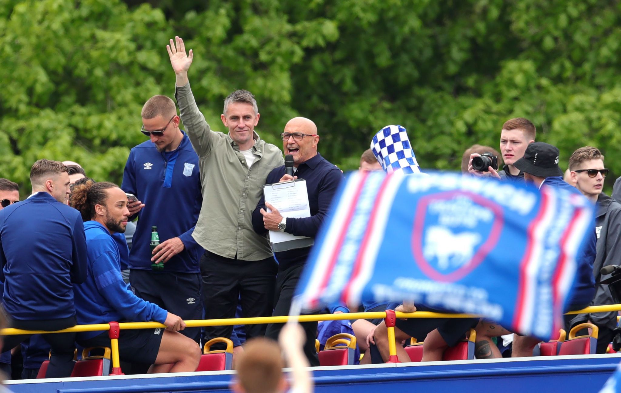 McKenna celebrates Premiership promotion with Ipswich Town in May - he is waving from the top of an open-top bus