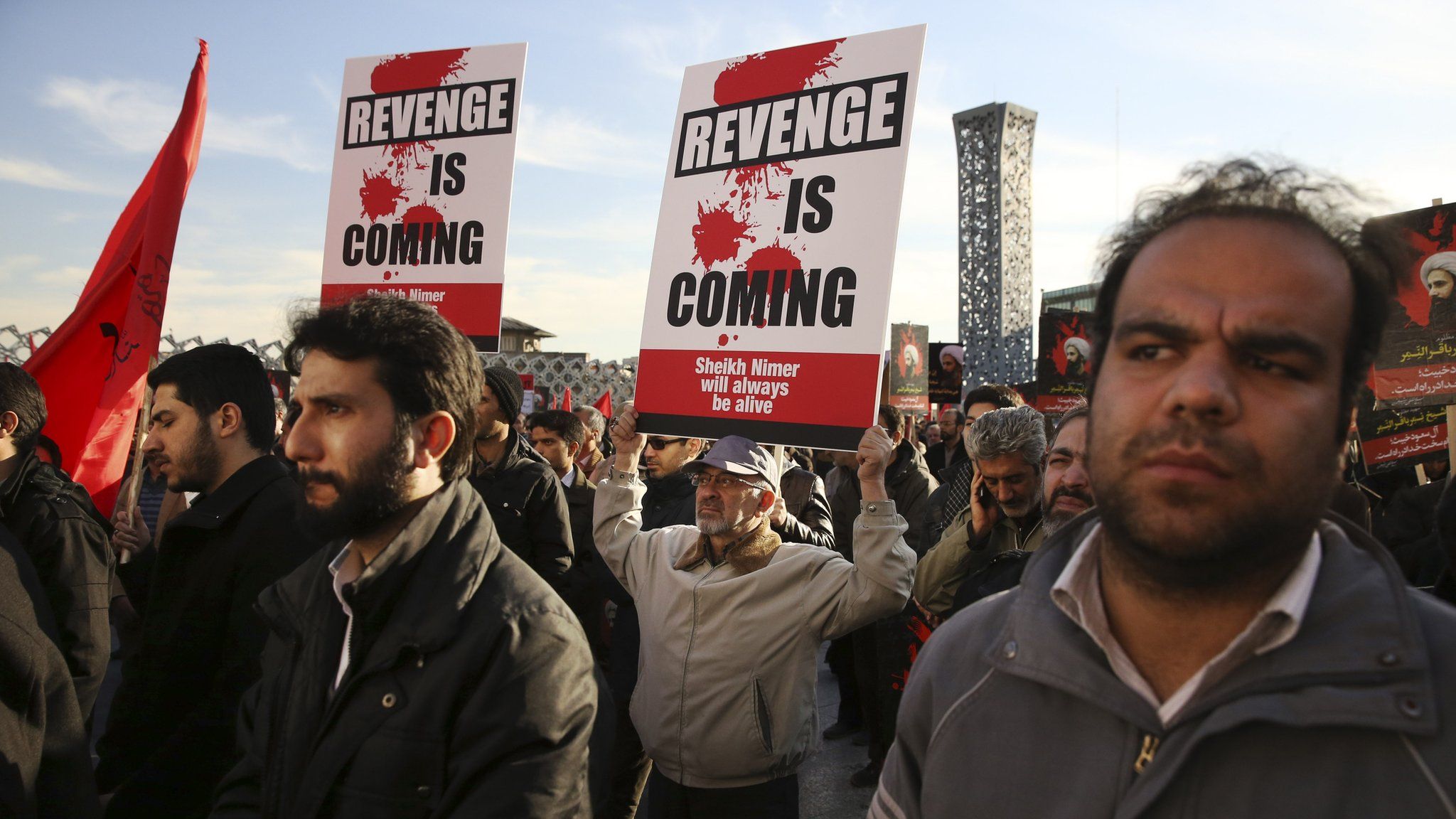 Iranian demonstrators hold anti-Saudi placards