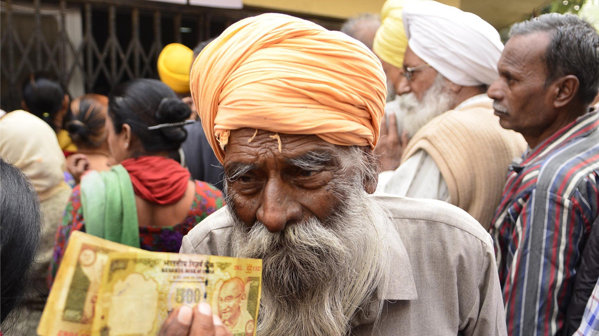 Man waits outside a bank to deposit and exchange 500 and 1000 rupee notes in Amritsar, India, in November 2016.