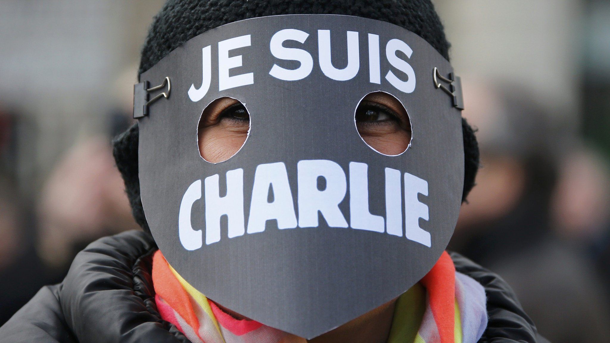 A women wearing a Je Suis Charlie mask in memory of the victims