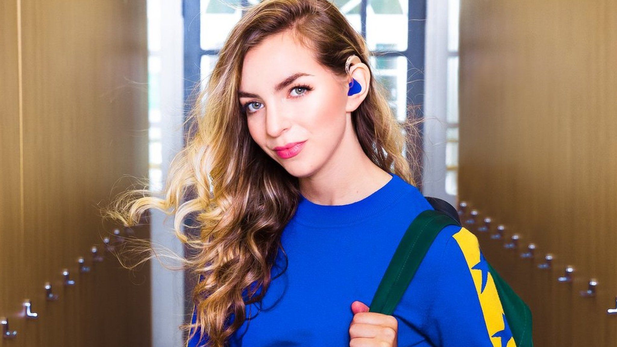 Hannah Fisher posing for a TV series with a hearing aid