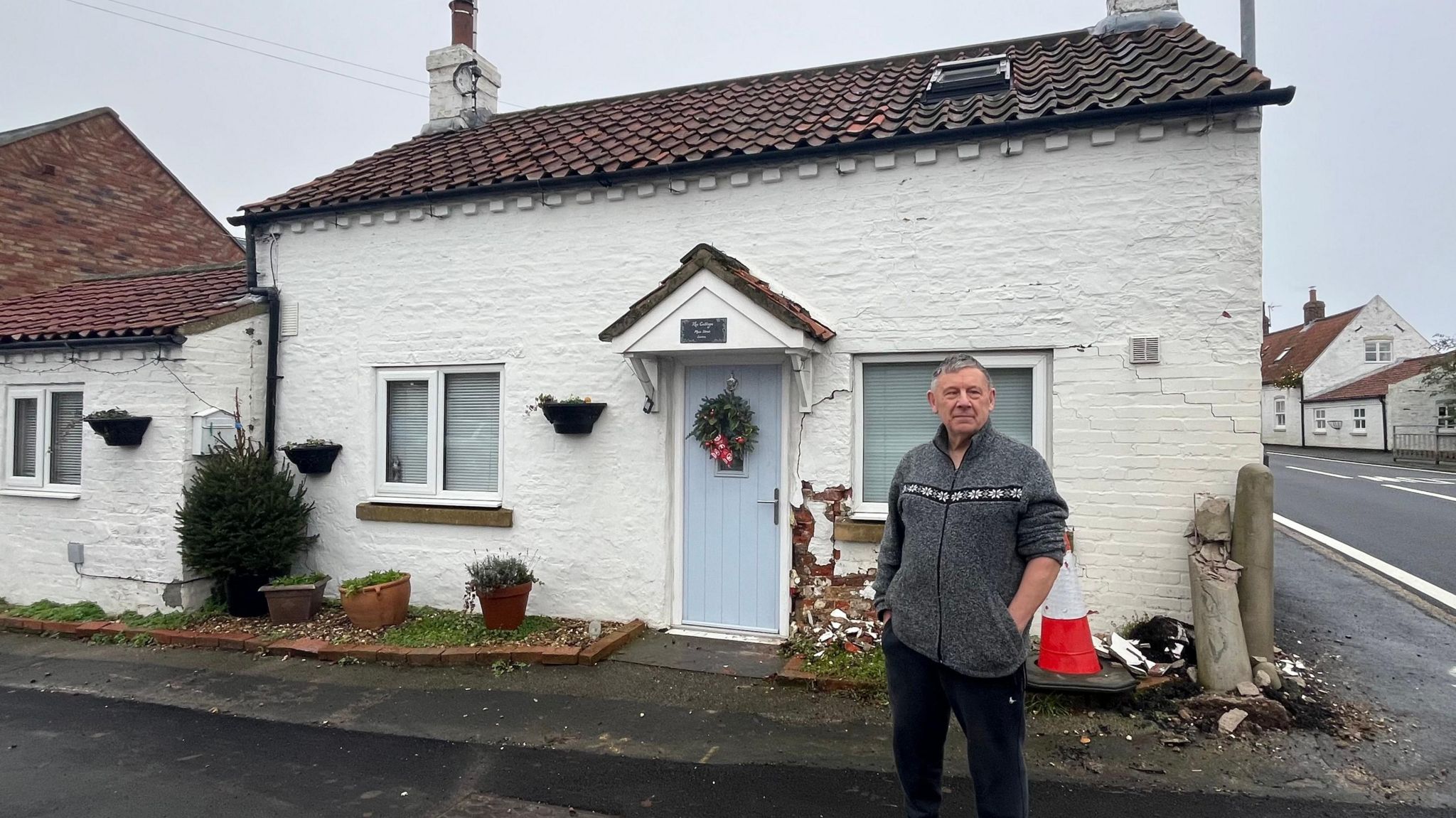 Seaton couple told house might collapse if they open front door - BBC News