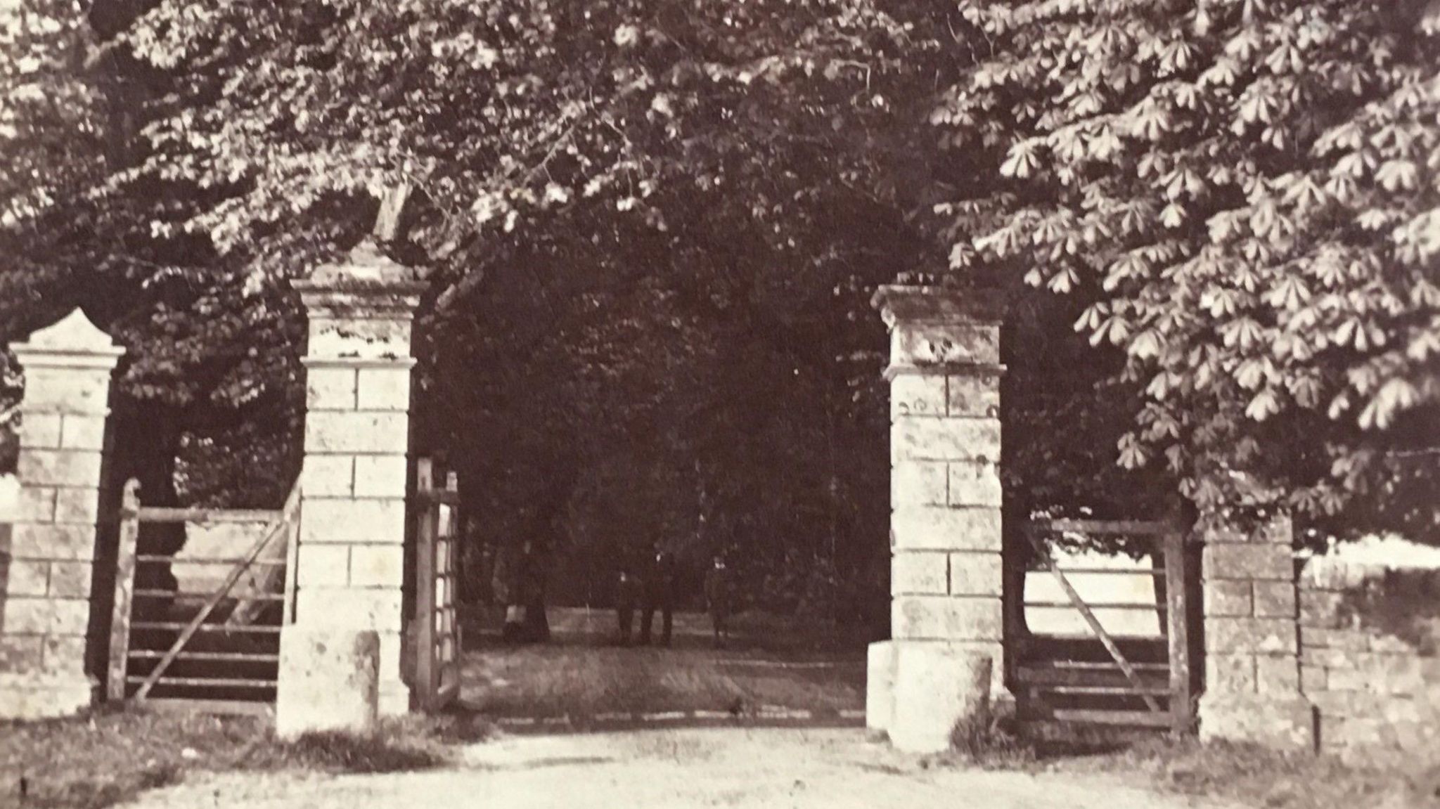 A grainy, black and white photograph of the Tissington village gates