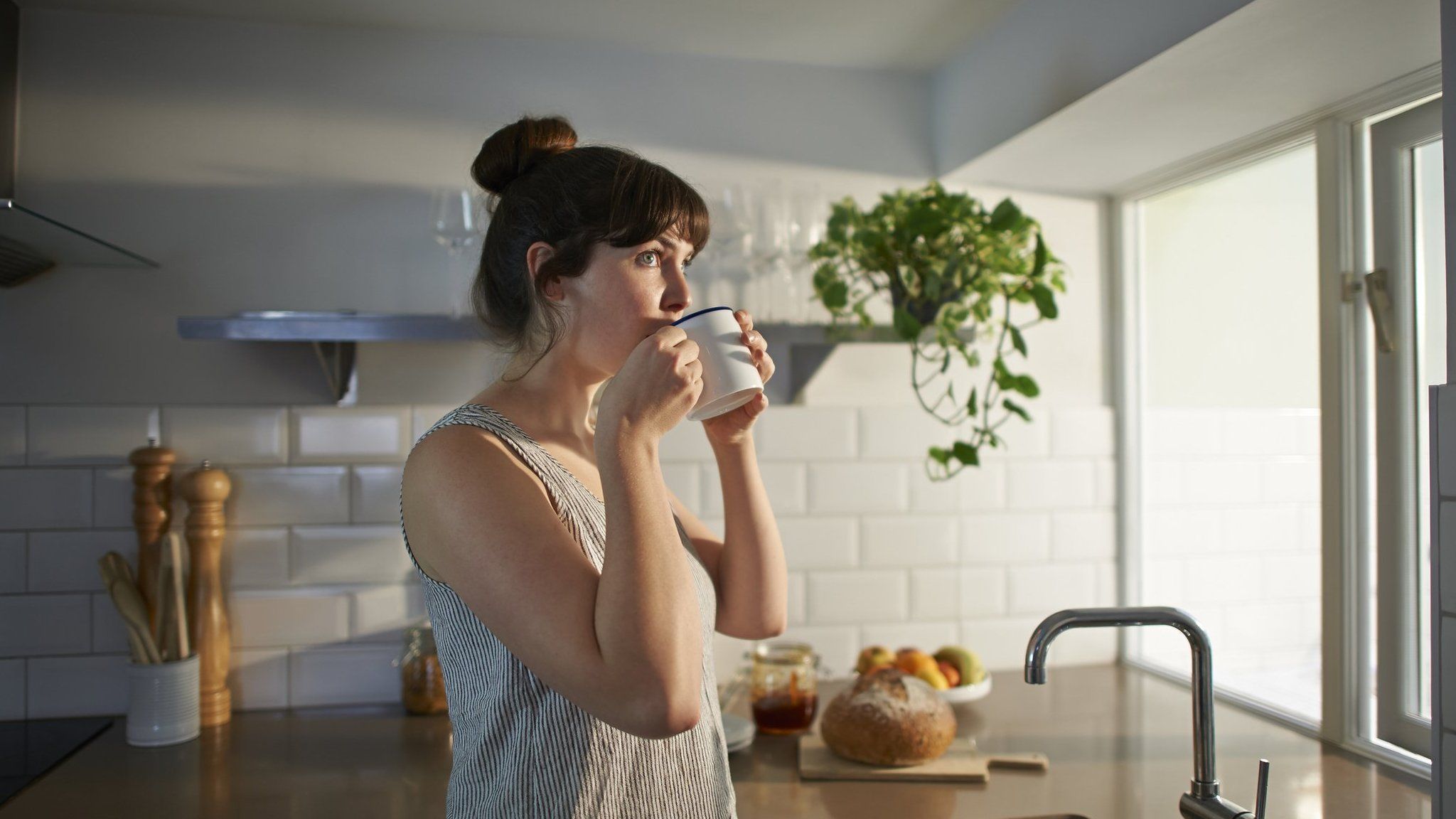 Photo of a woman drinking tea at home