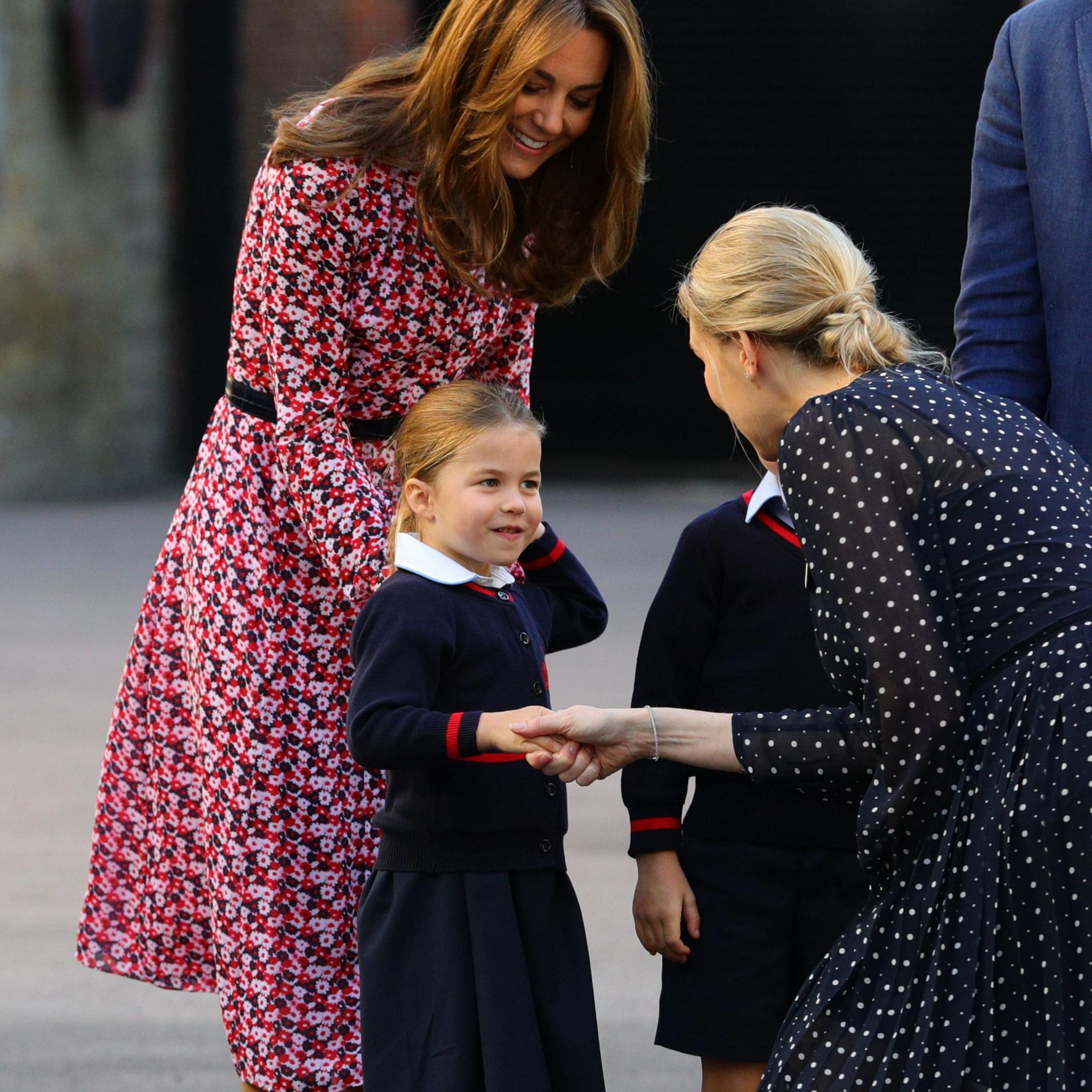 Princess Charlotte is greeted by Helen Haslem, head of the lower school at Thomas's Battersea, on her first day of school