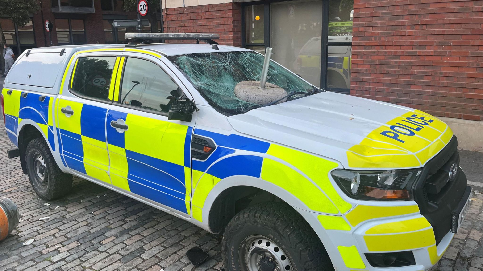 A police car with a smashed window