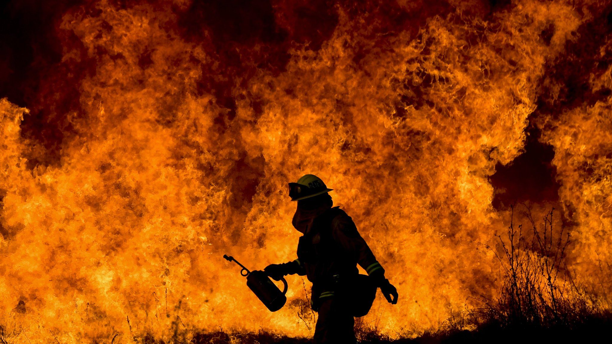 A firefighter battling the flames