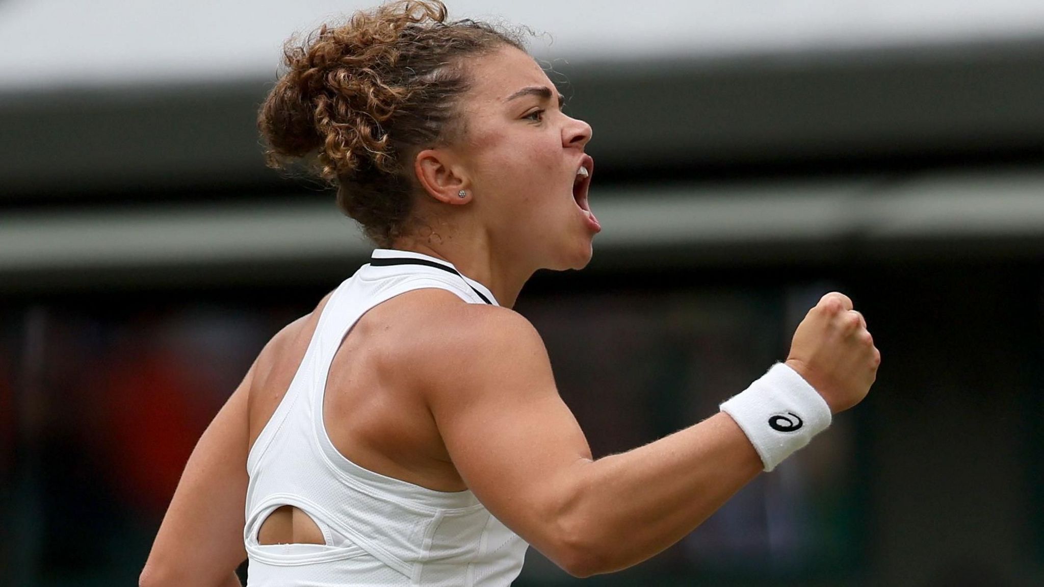 Jasmine Paolini shouts and pumps her first after winning a point in her Wimbledon third-round match against Bianca Andreescu