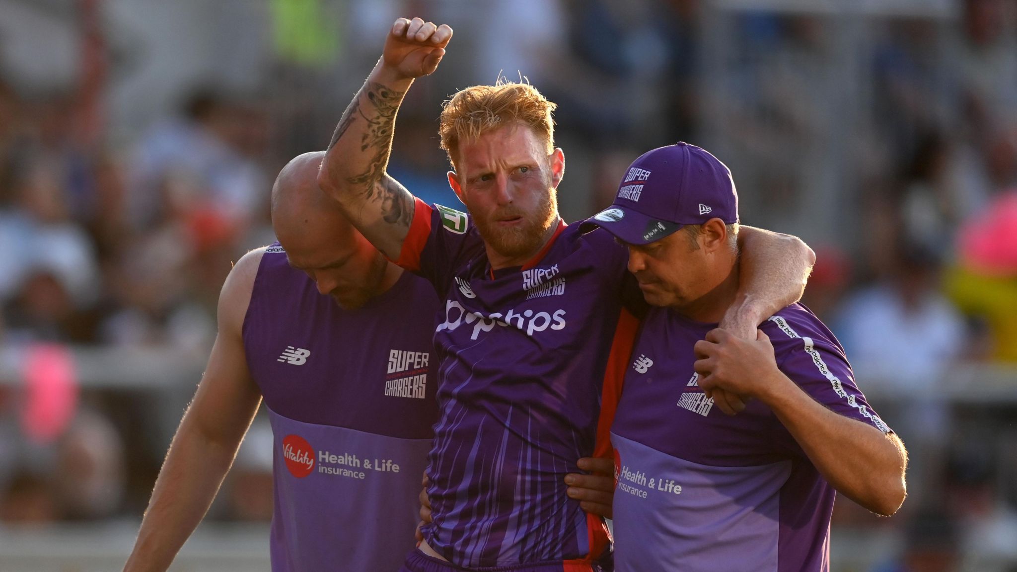 Ben Stokes being carried off the field by two members of Northern Superchargers' staff