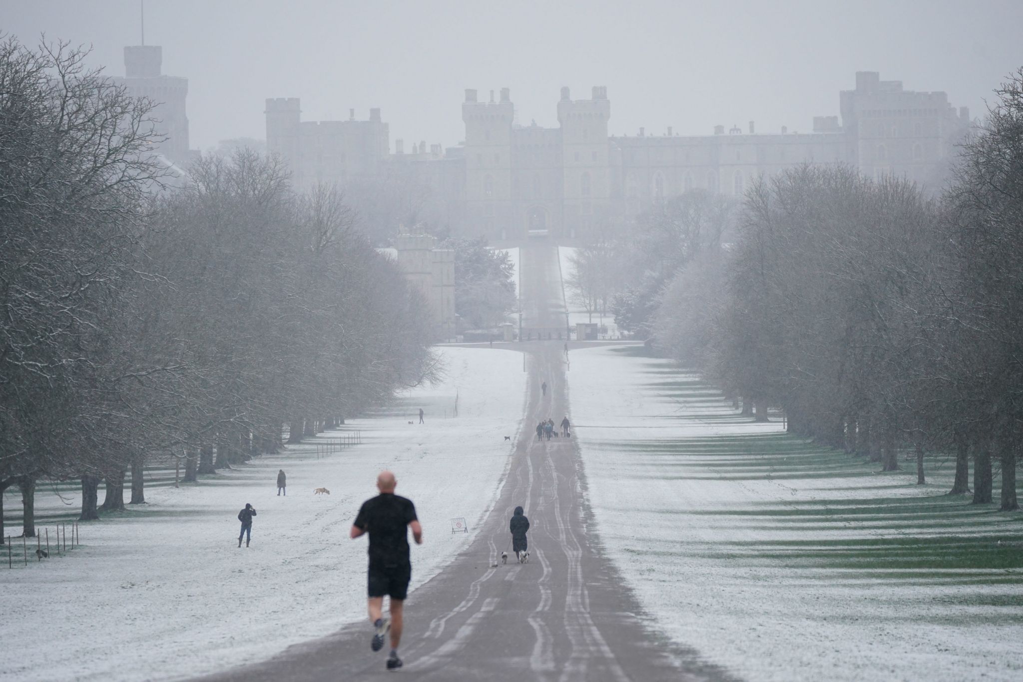 A runner braves the cold alongside dogwalkers on the Long Walk in Windsor