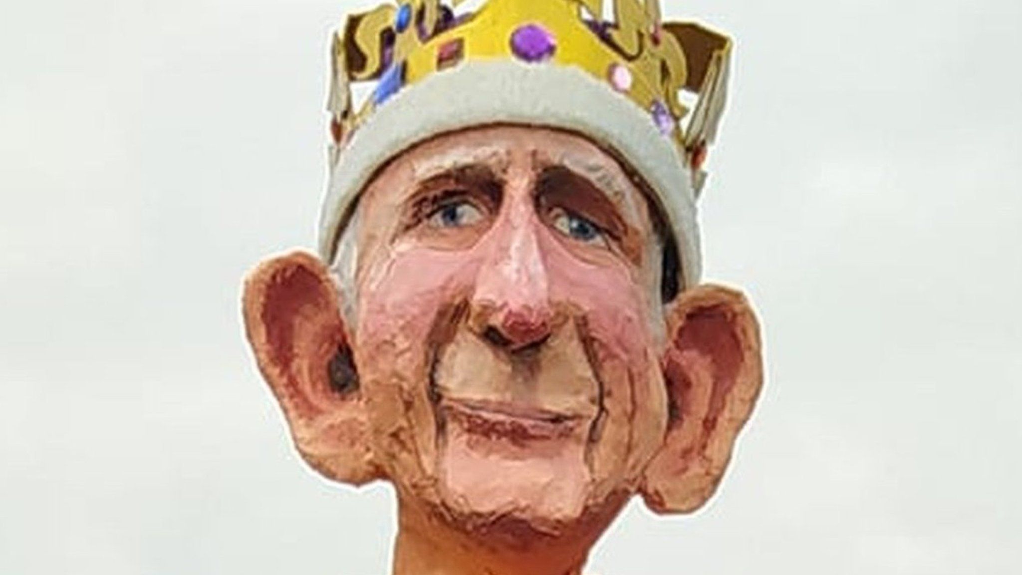 Model of King Charles sitting on a garden fence.