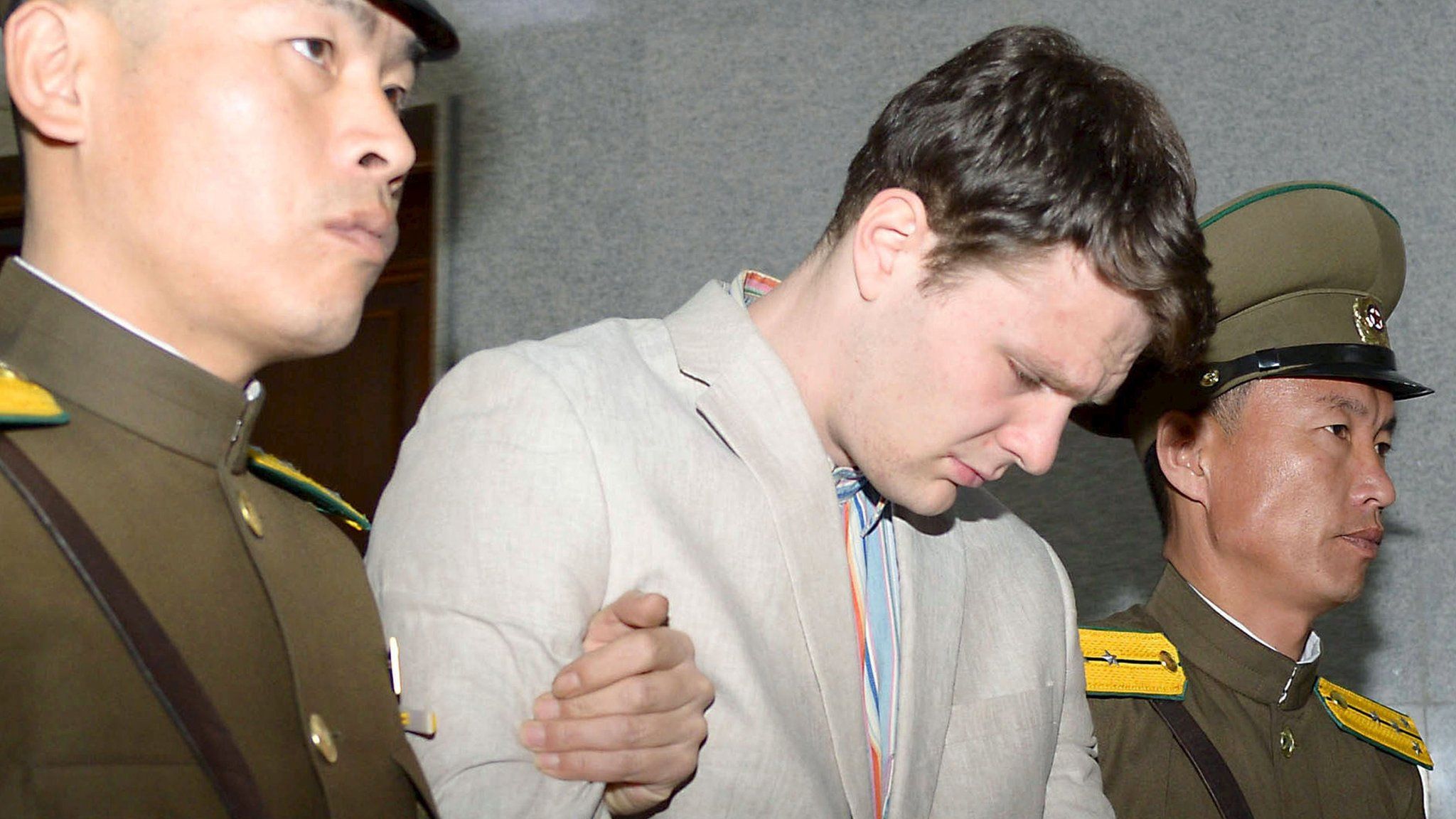 Otto Frederick Warmbier being taken out of court