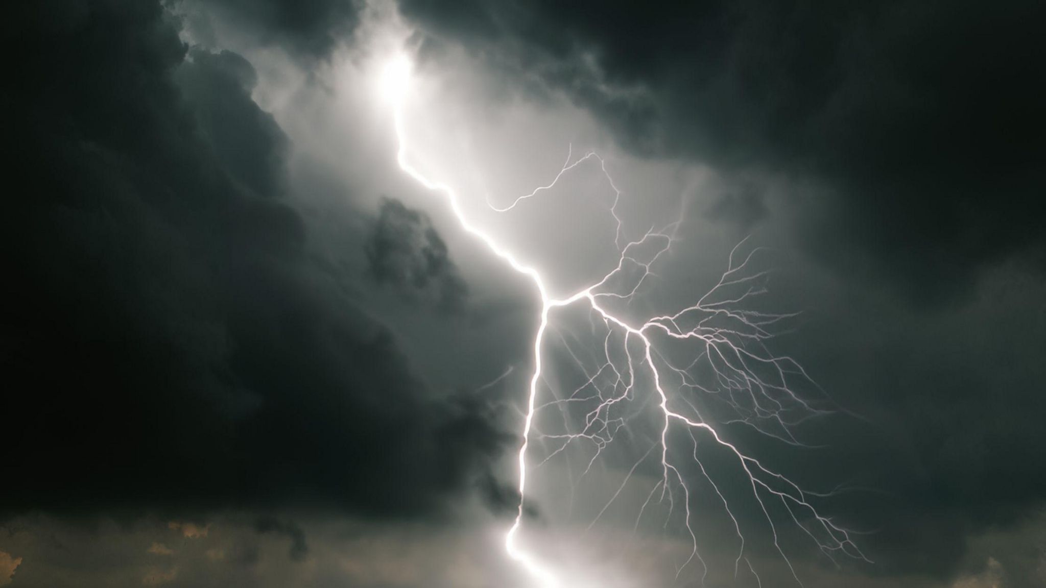 A stock image shows a fork of lightning and dark clouds.