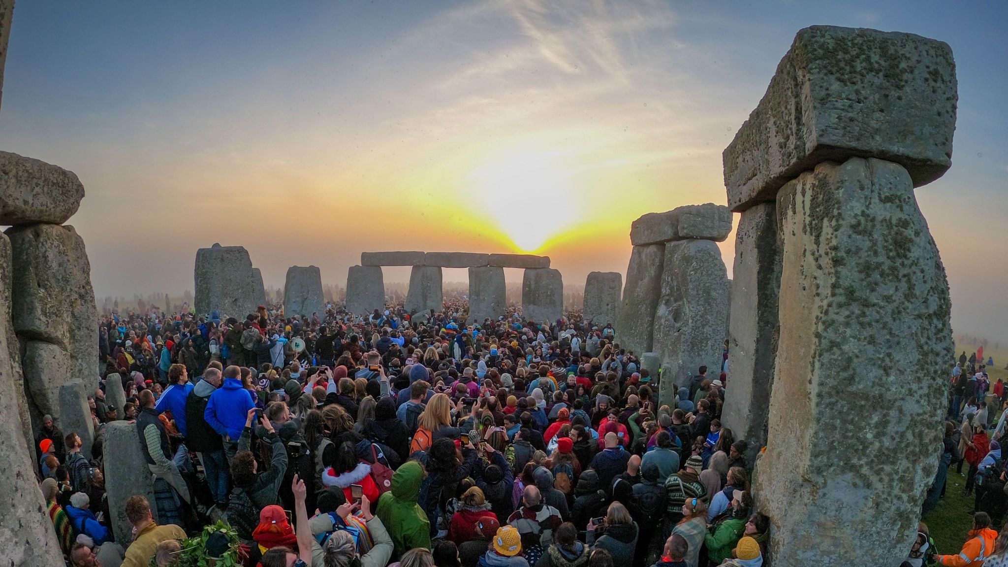 Crowds at Stonehenge as the sun sets