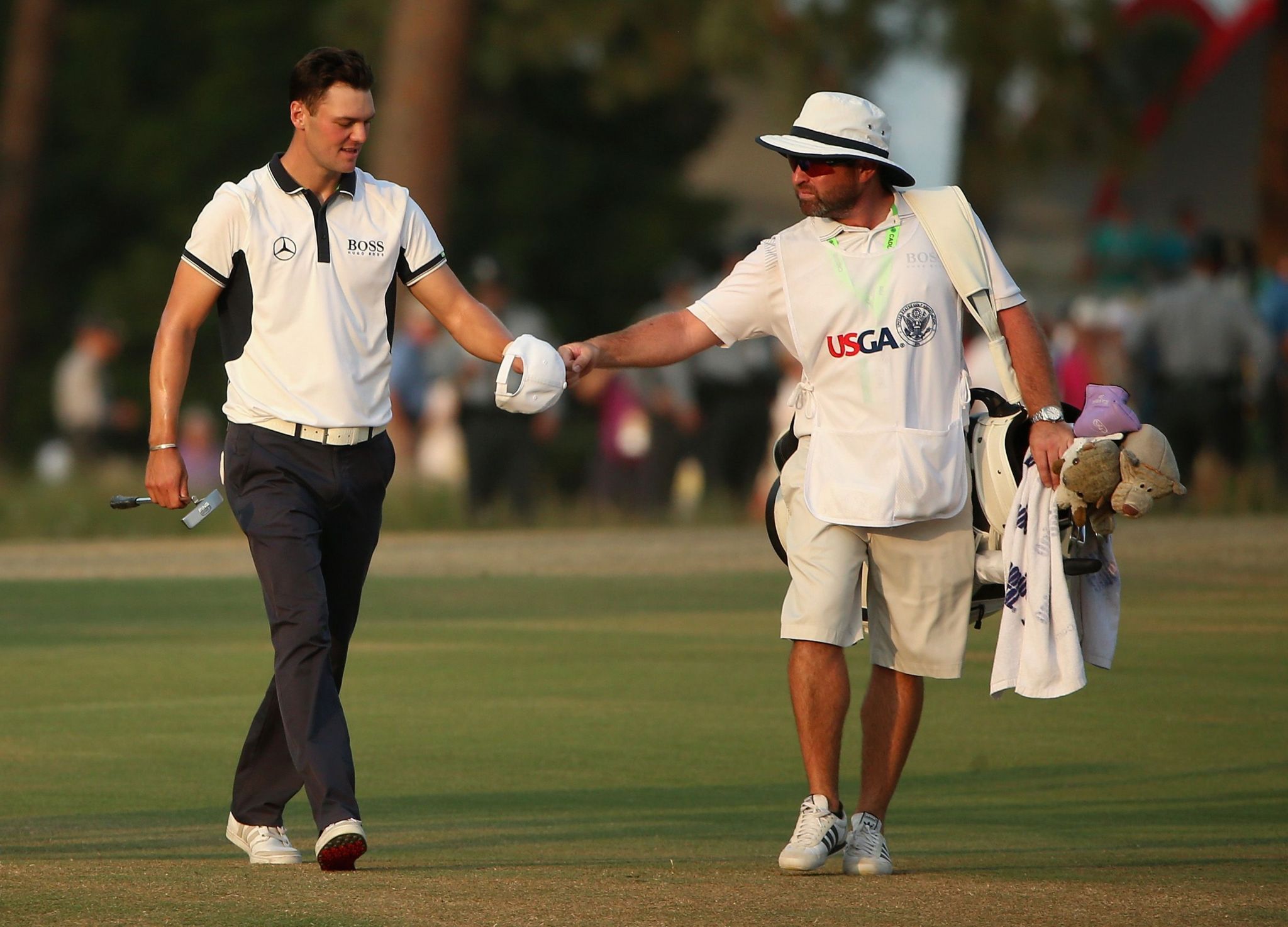 Martin Kaymer and his caddie Craig Connelly walk down the 18th fairway knowing that the 2014 US Open victory at Pinehurst is in the bag