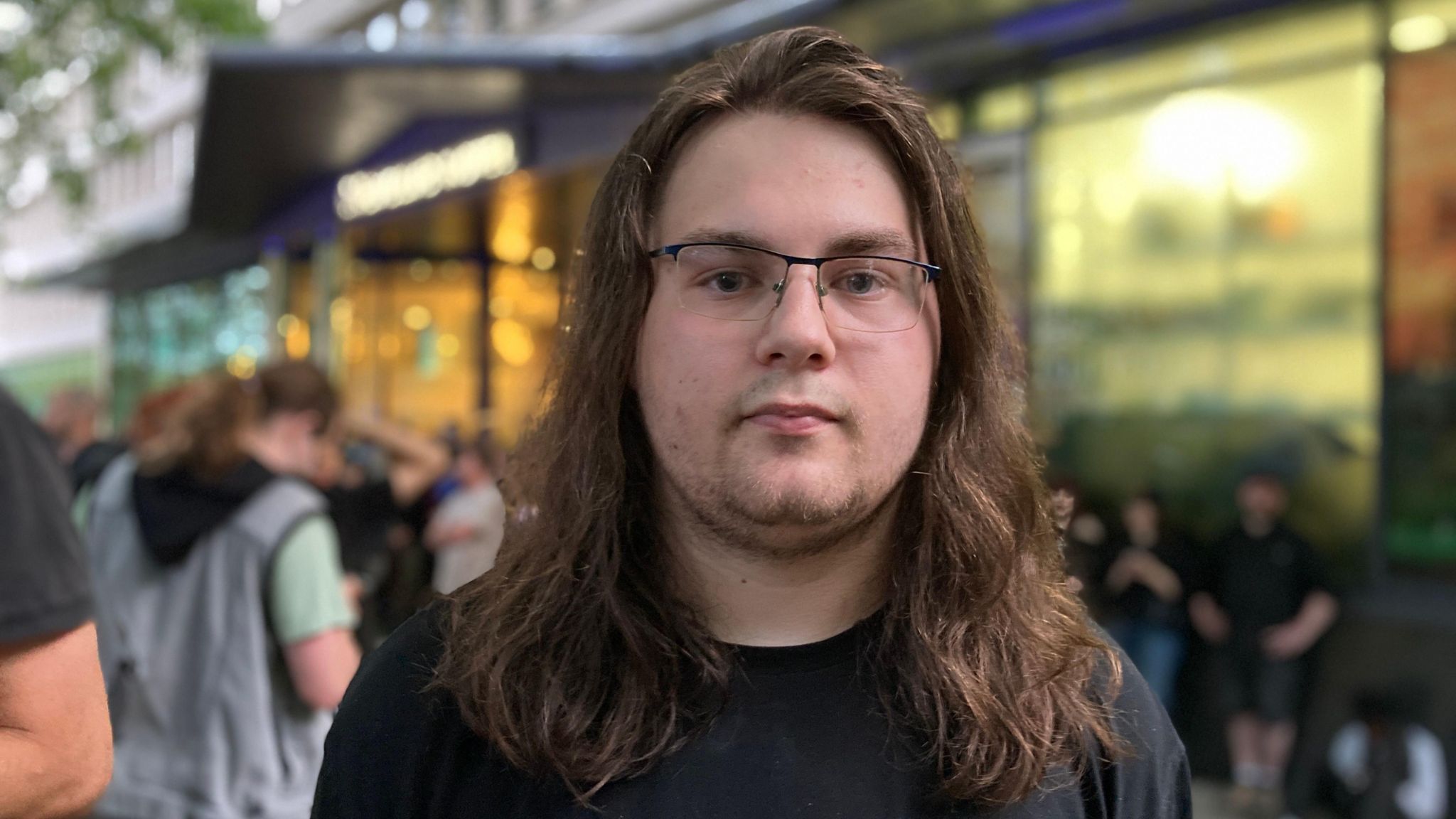 A man with shoulder length brown hair