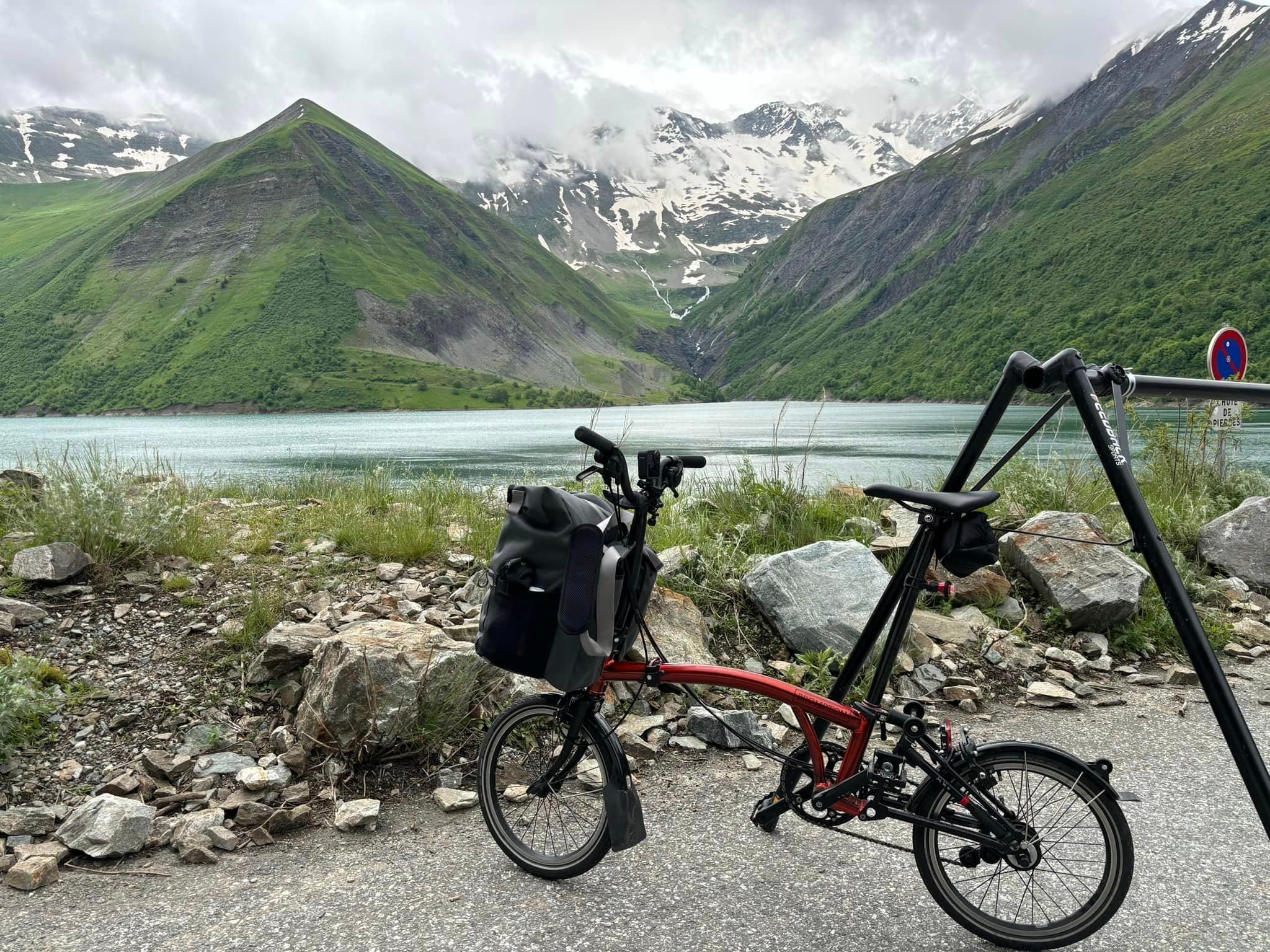 A foldable bike in front of a snowy mountain range