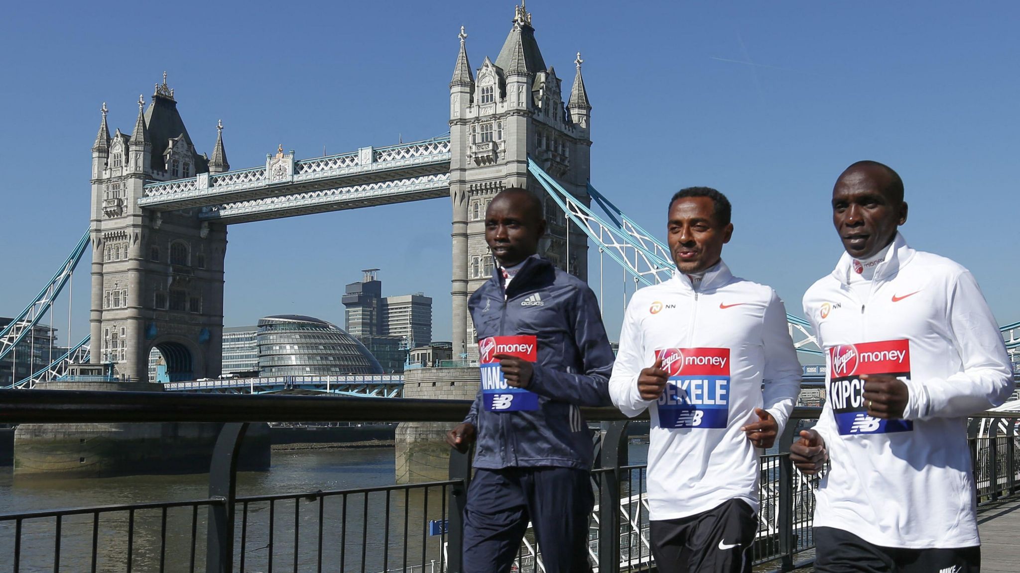 Kenya's Daniel Wanjiru, Ethiopia's Kenenisa Bekele and Kenya's Eliud Kipchoge pose during a photocall for the London marathon by Tower Bridge