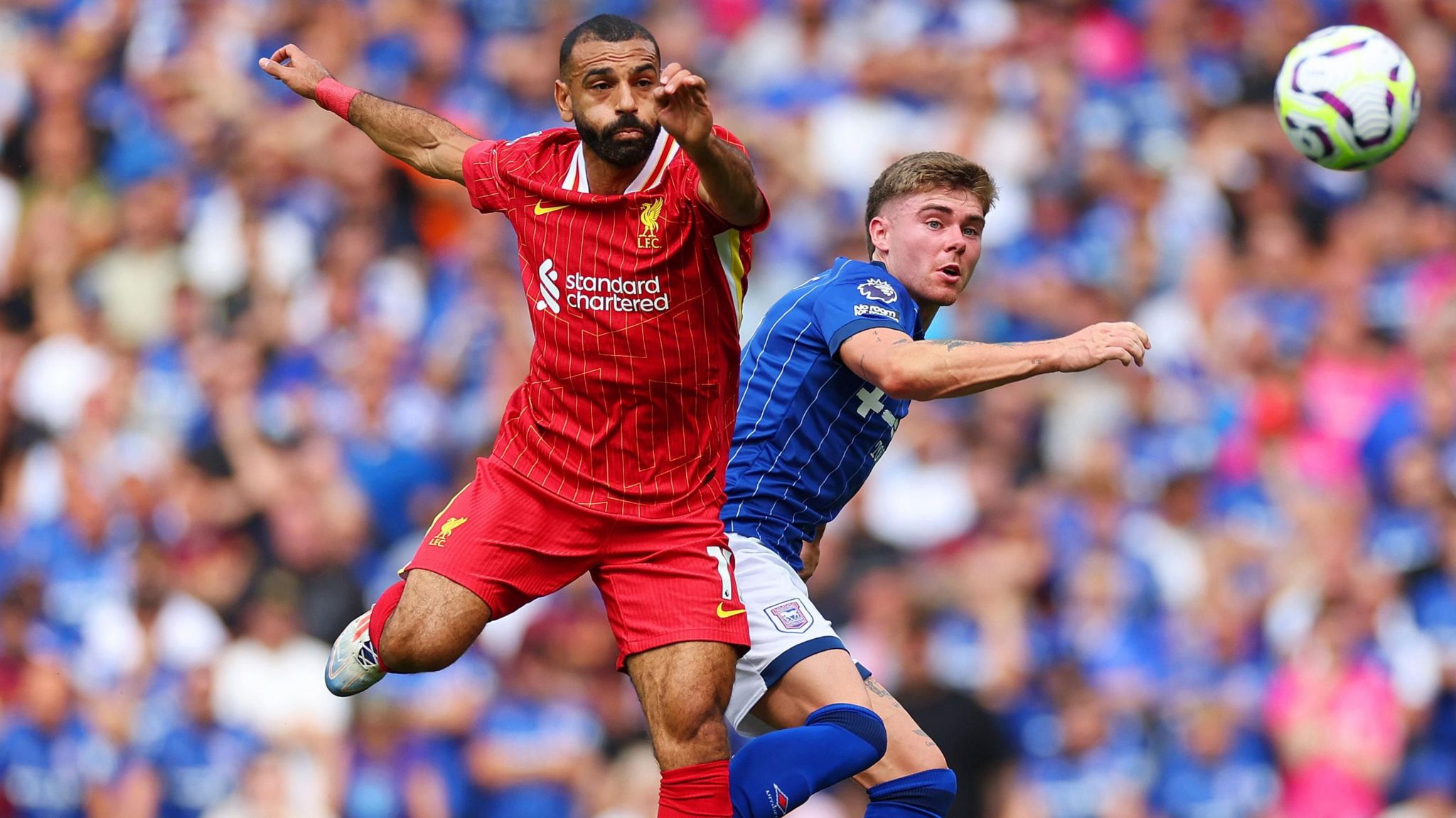 Mohamed Salah and Leif Davis challenge for the ball at Portman Road