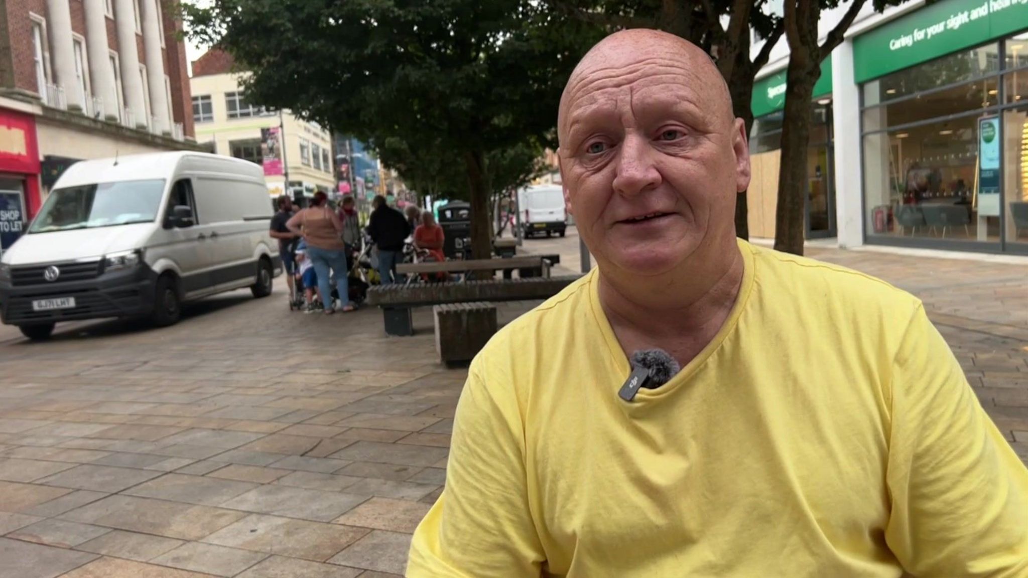 David Sensier in Hull city centre with shaven head and wearing a yellow T-shirt